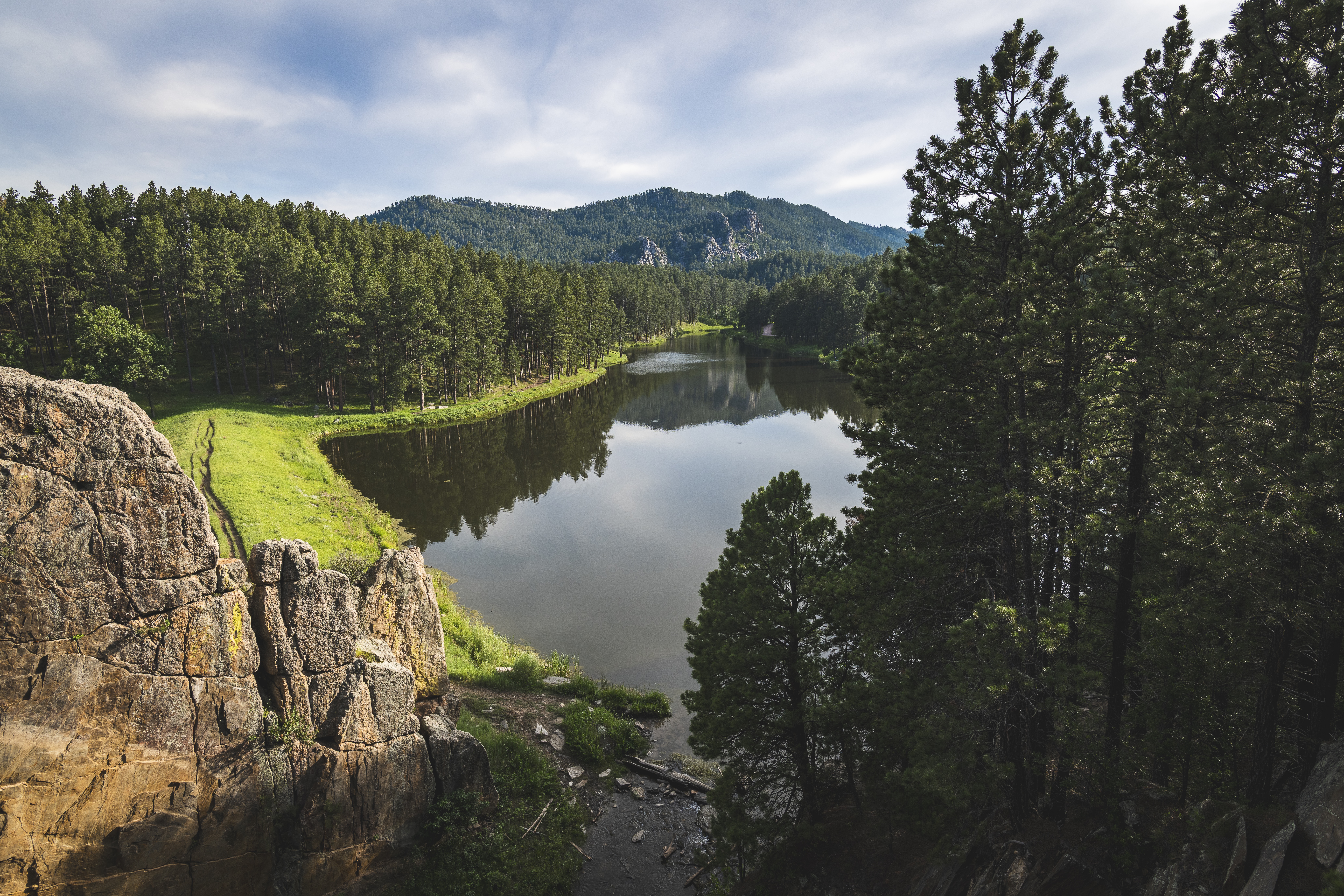 A serene lake surrounded by lush forests.