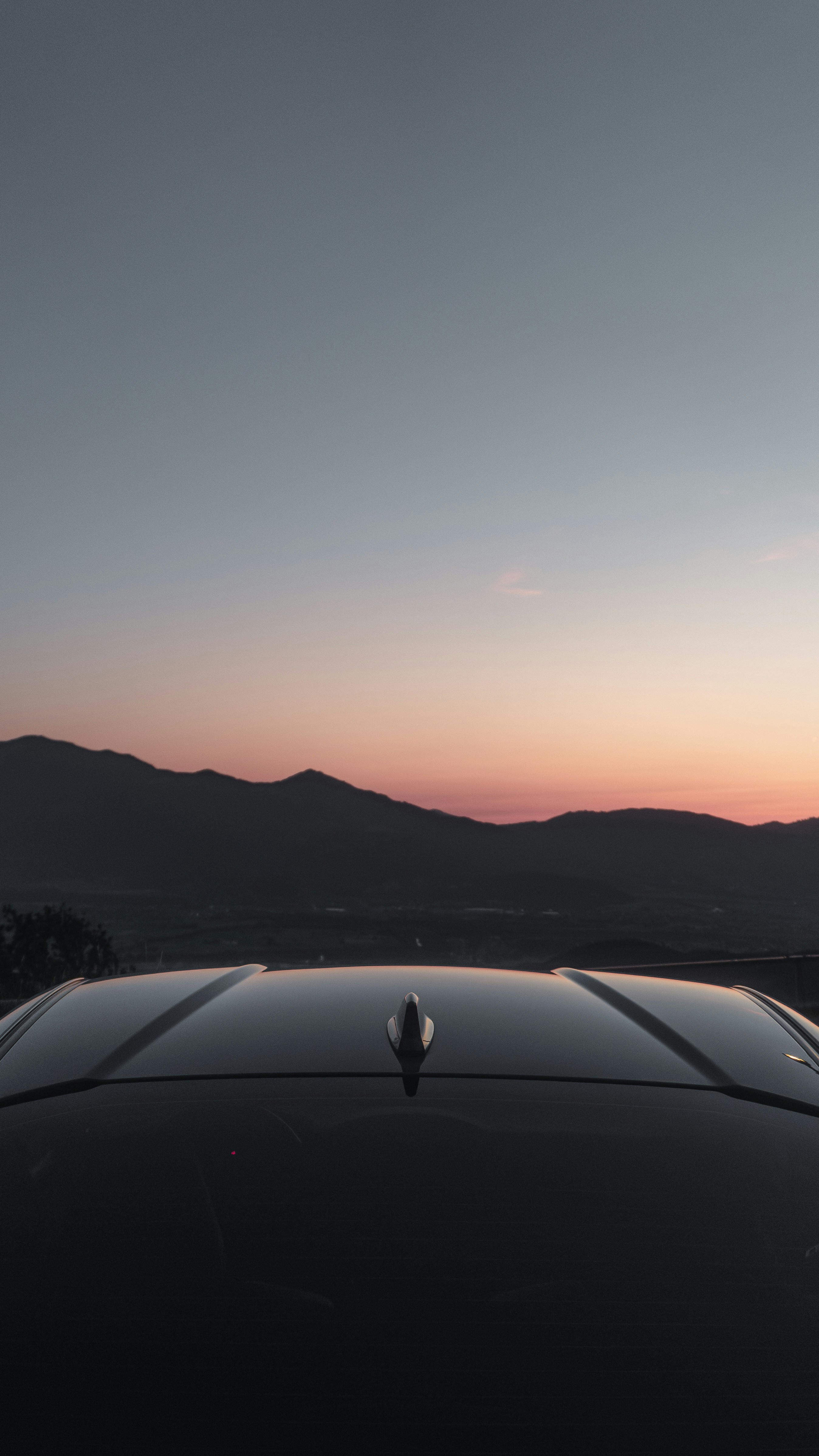 Car roof with a sunset over the mountains.