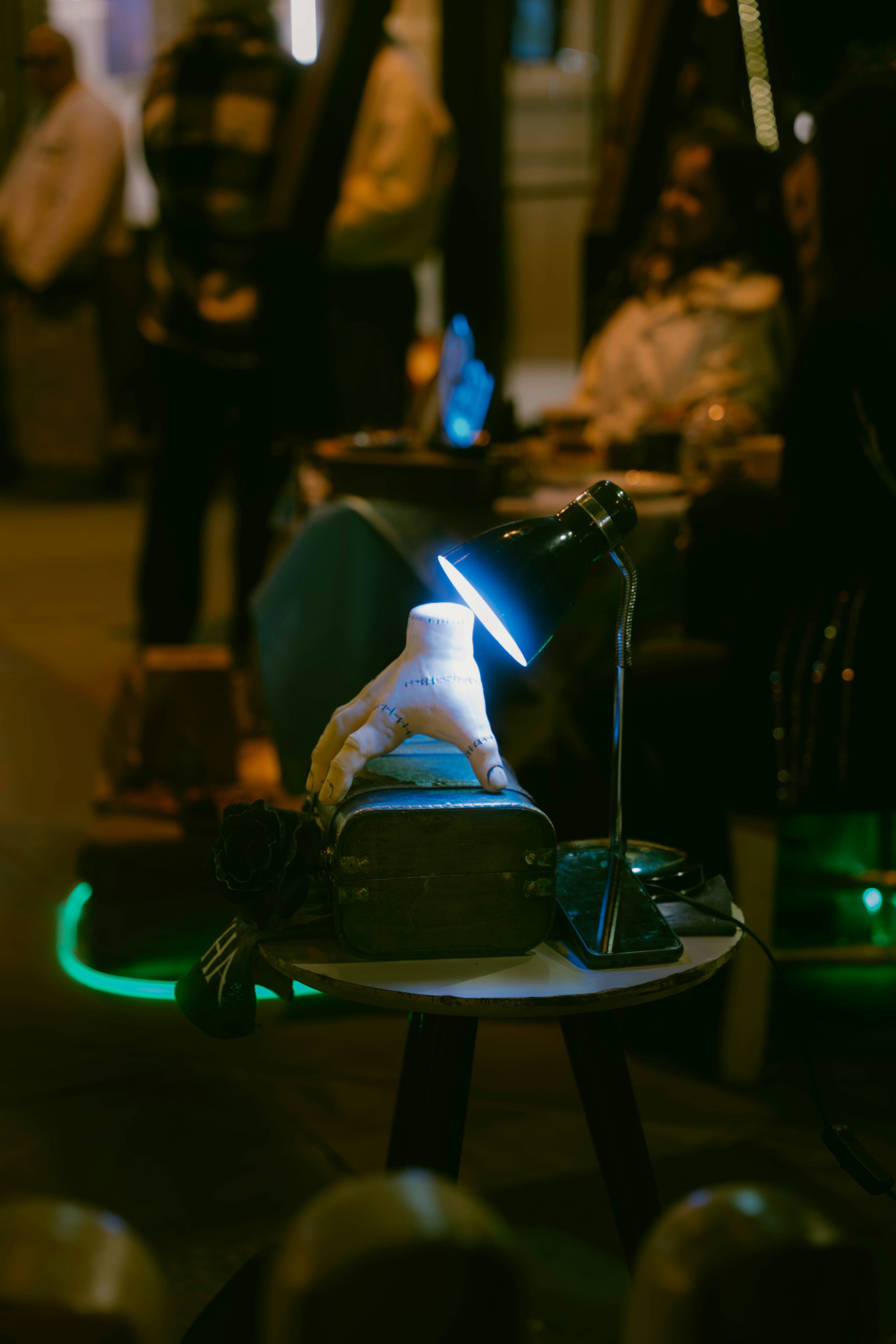 A hand and vr headset are illuminated by a lamp.