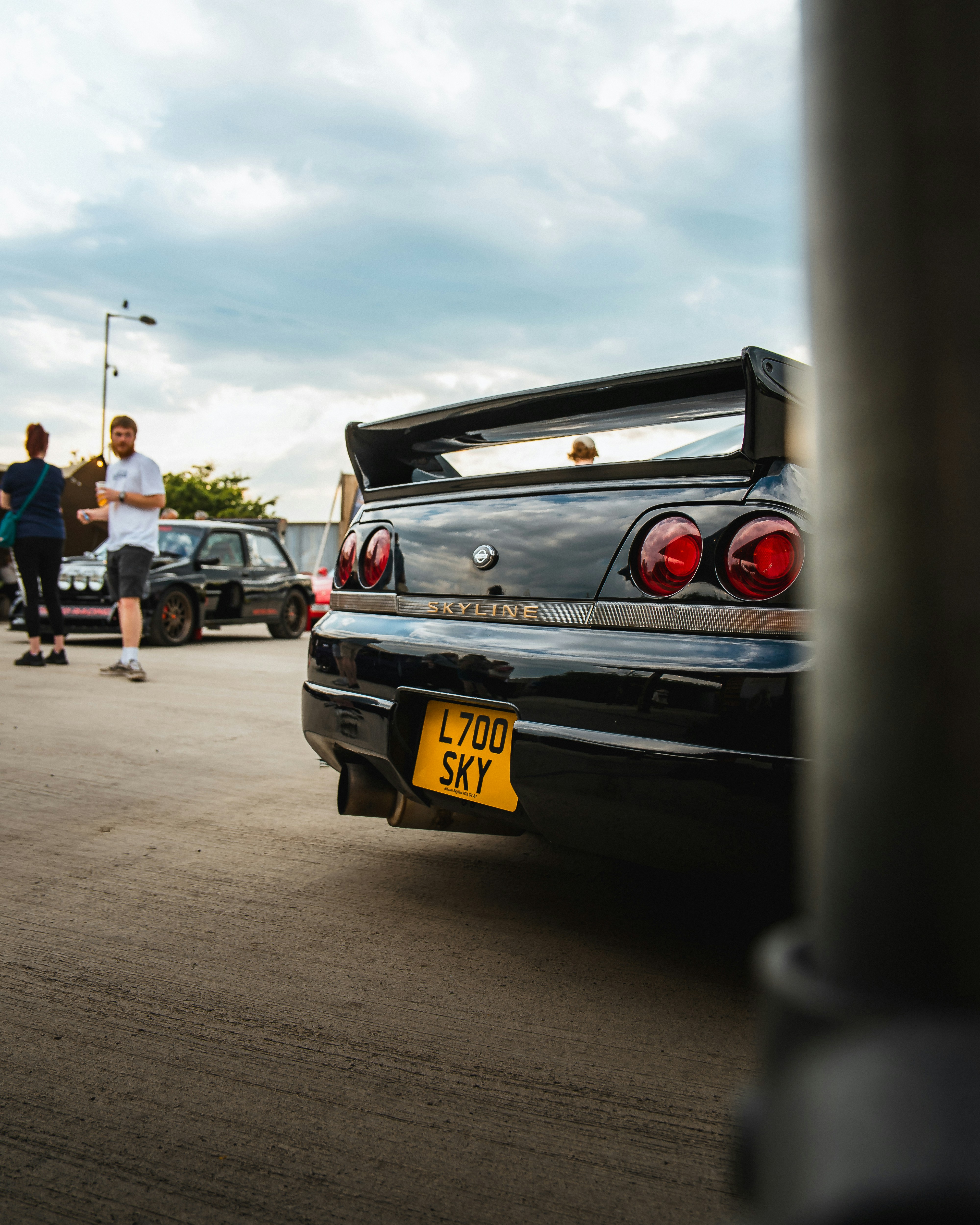 A black nissan skyline showcases its rear.