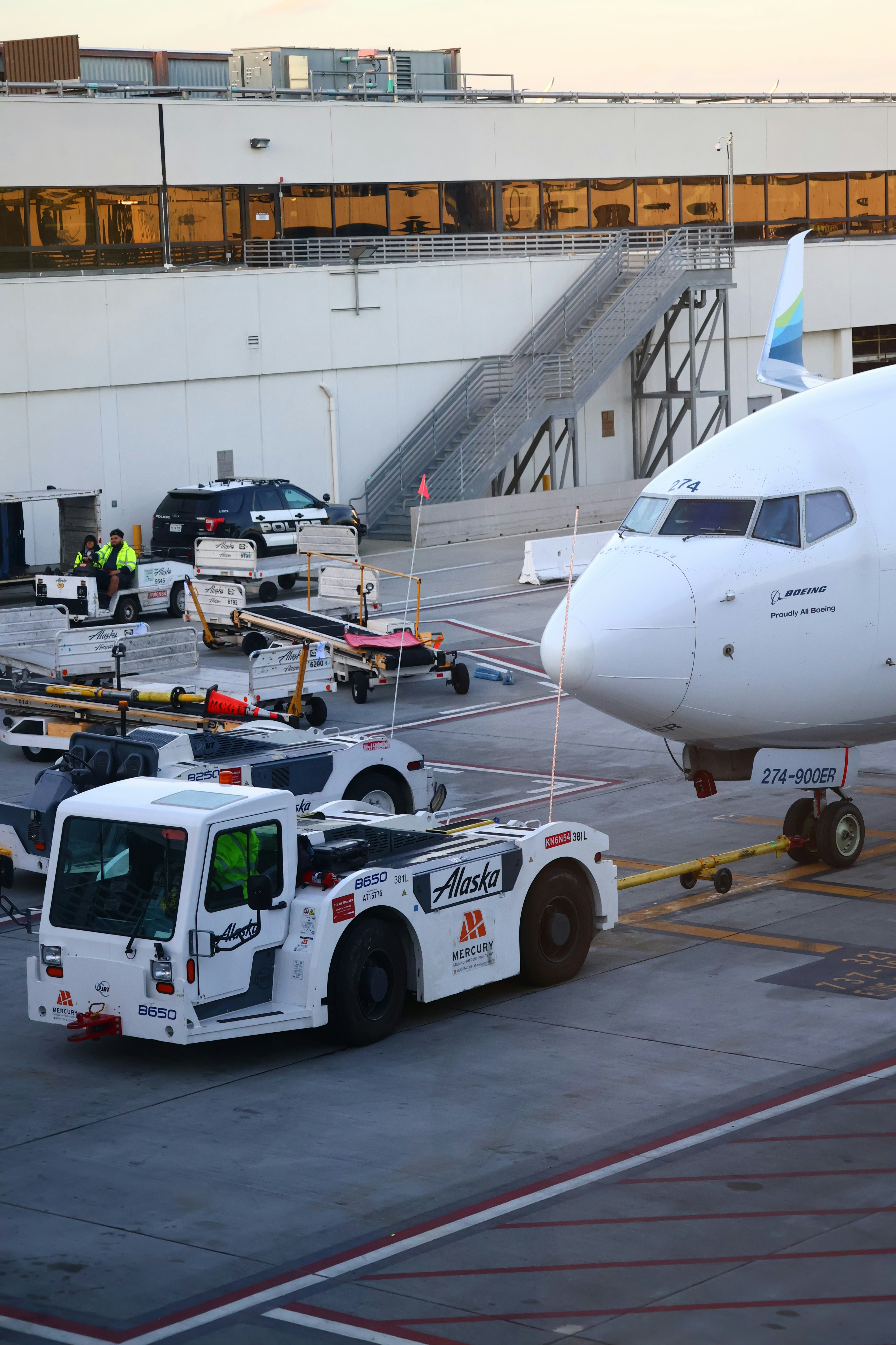 An airplane is being towed by a specialized vehicle.