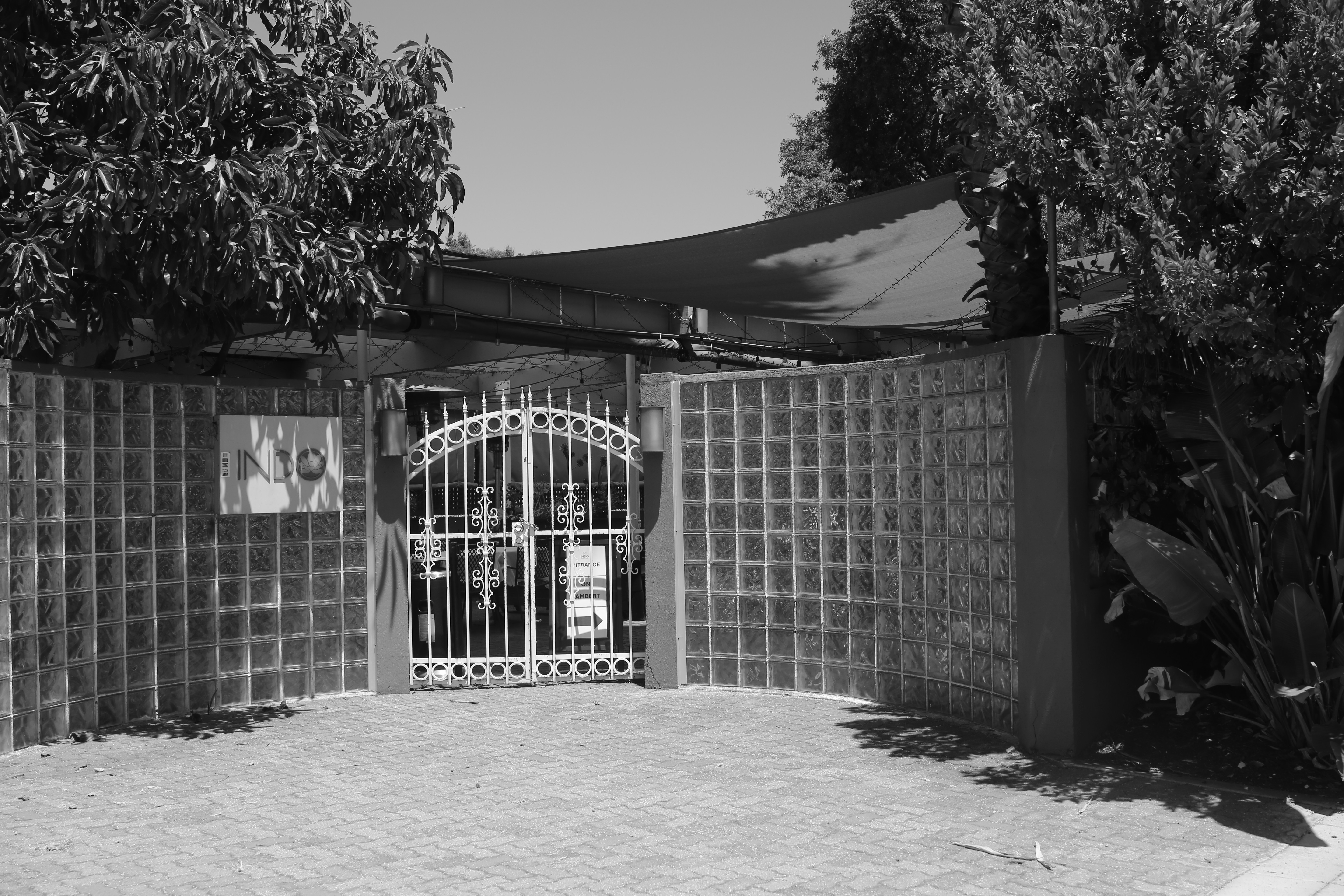 A gated entrance leads to a building.
