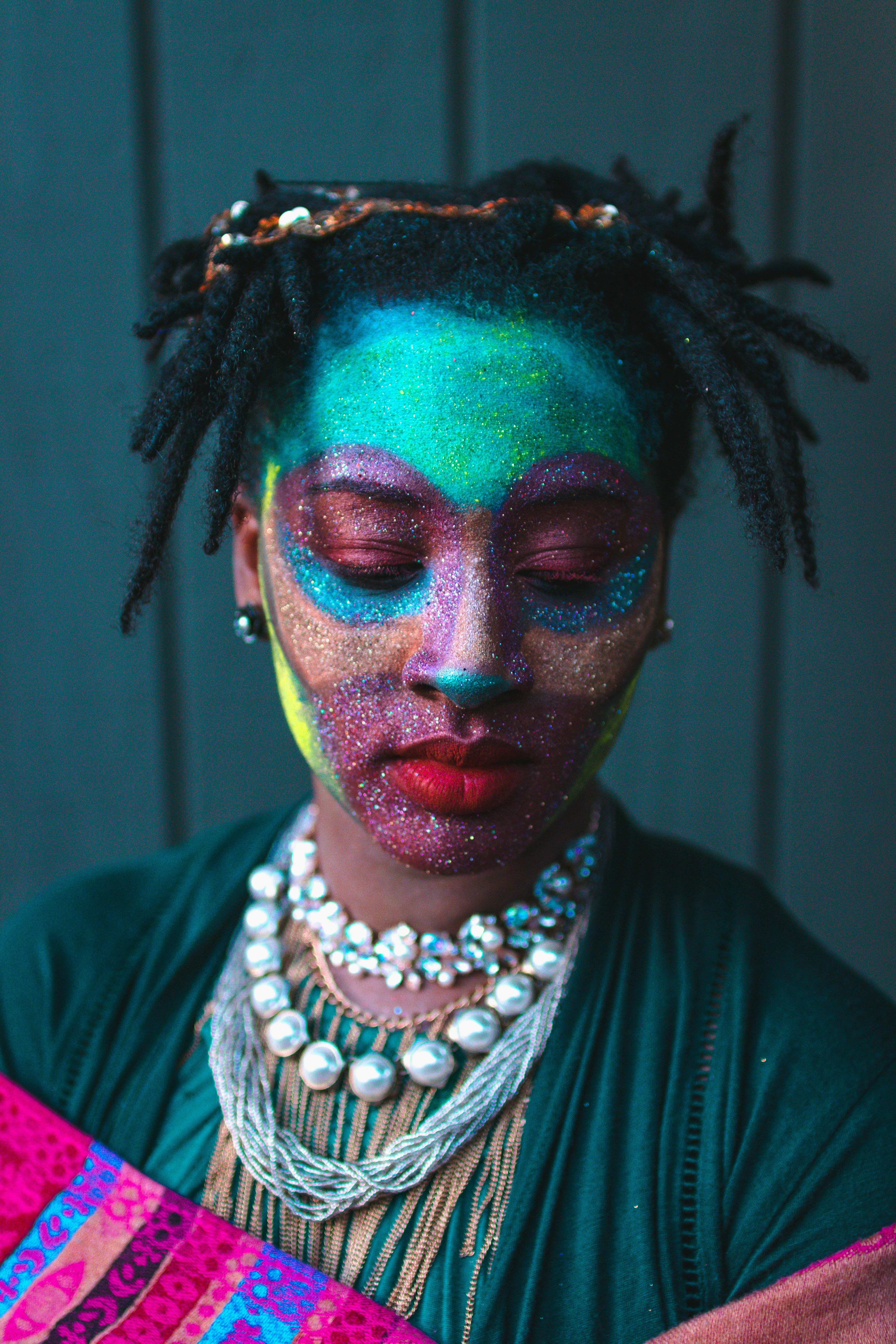 A woman with face paint and closed eyes.