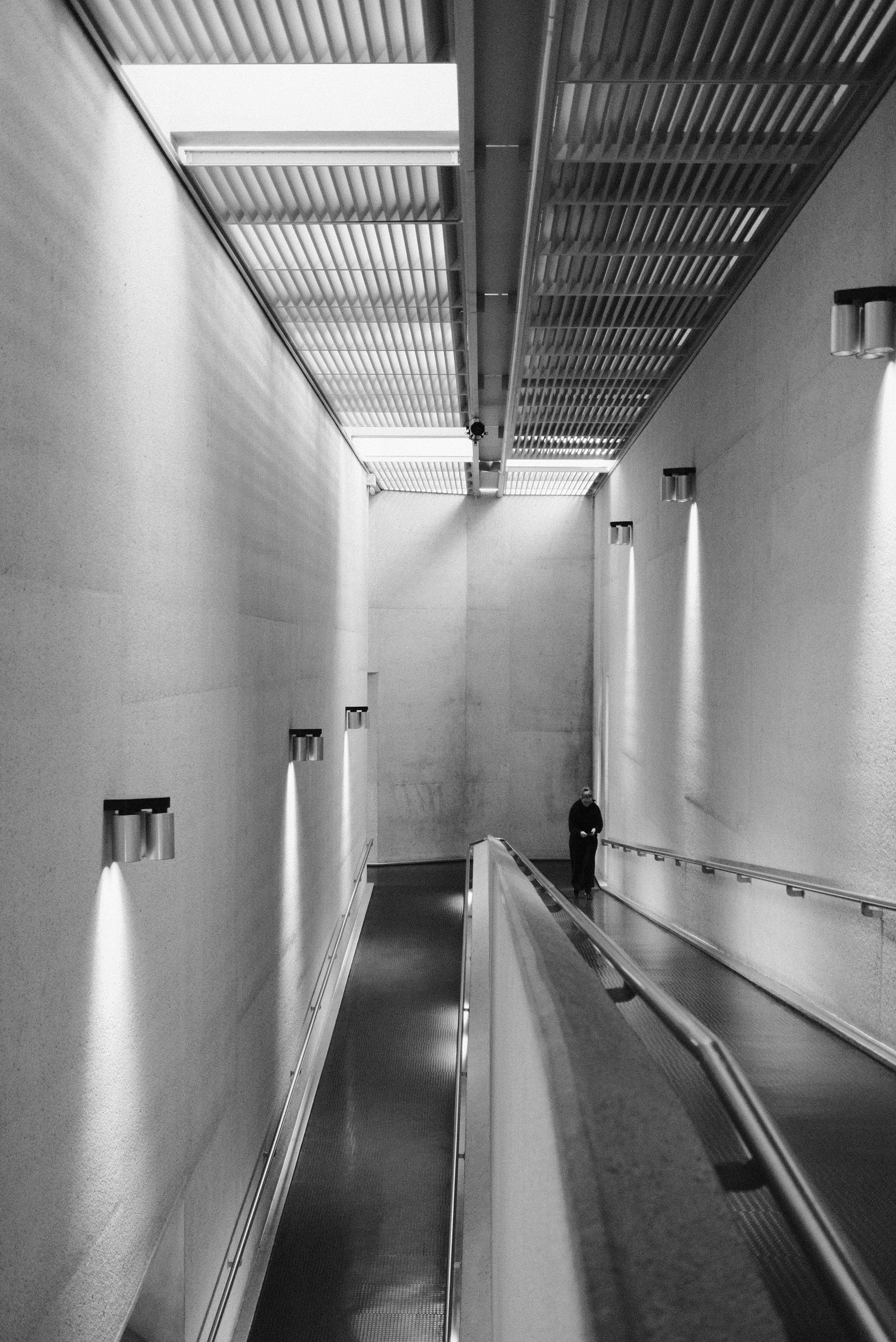 Una persona camina por un pasillo moderno e iluminado.