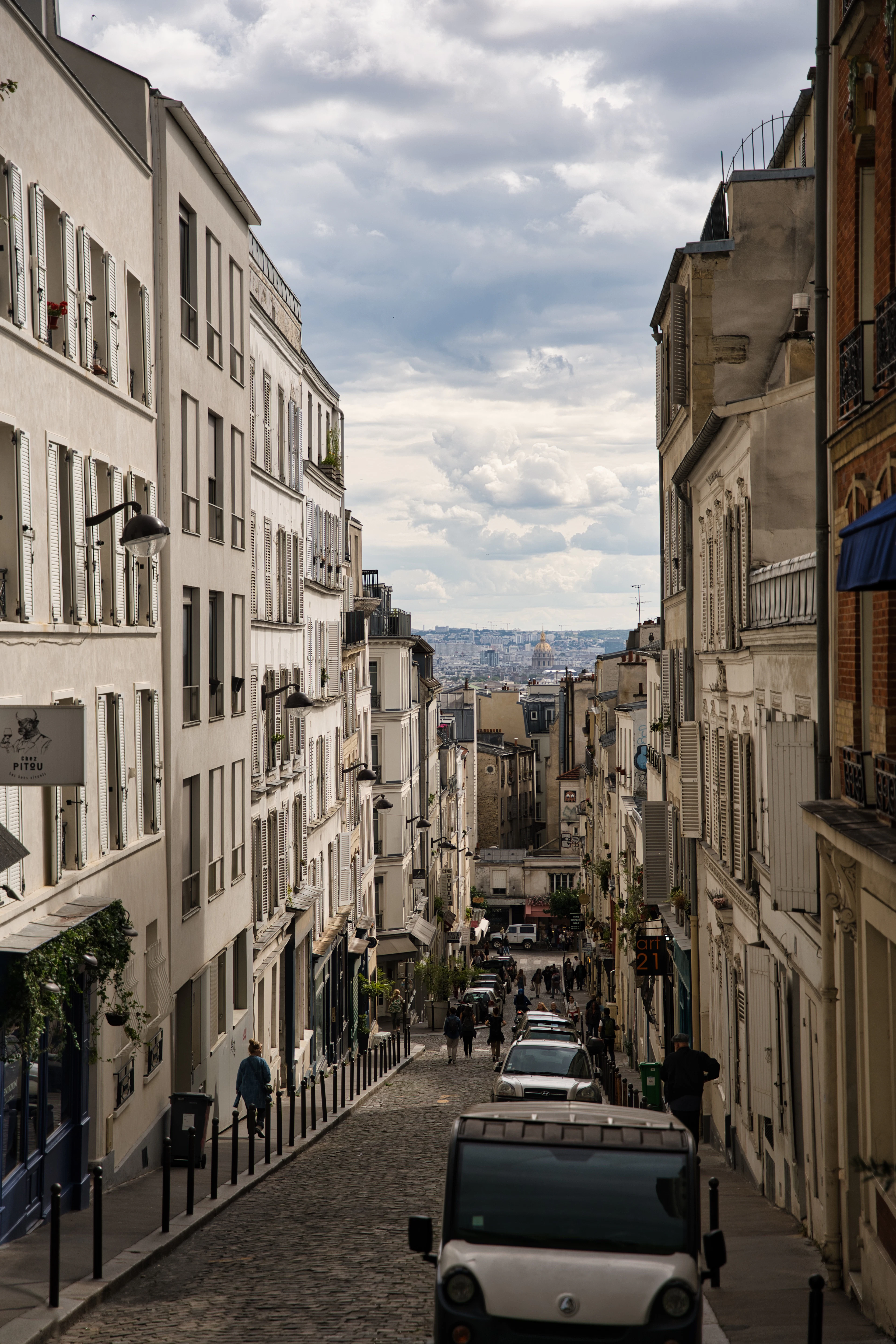 A narrow Paris street lined with shopfronts