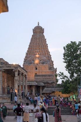 A temple tower stands tall with people gathered below.