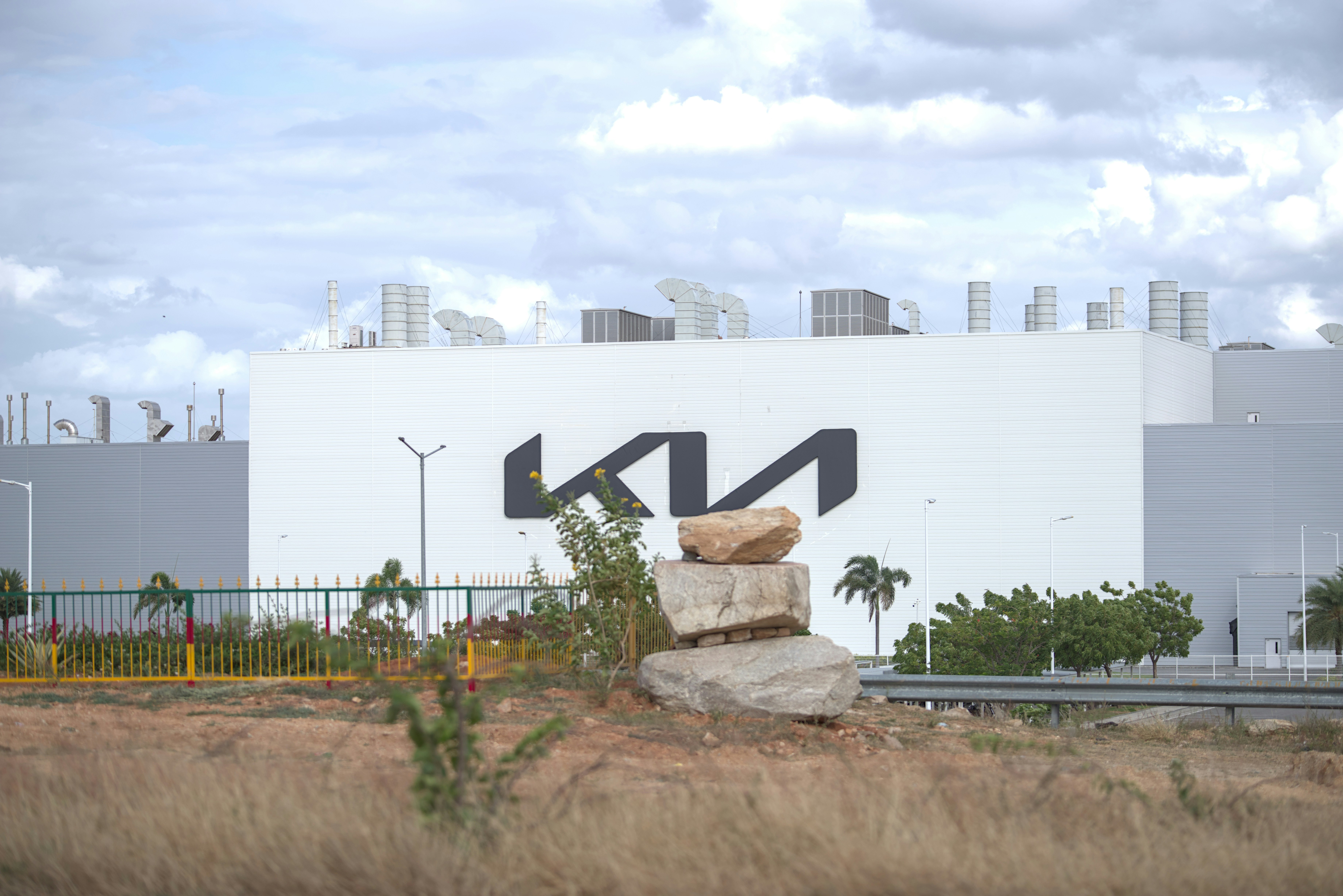 The kia logo adorns the side of a large building.