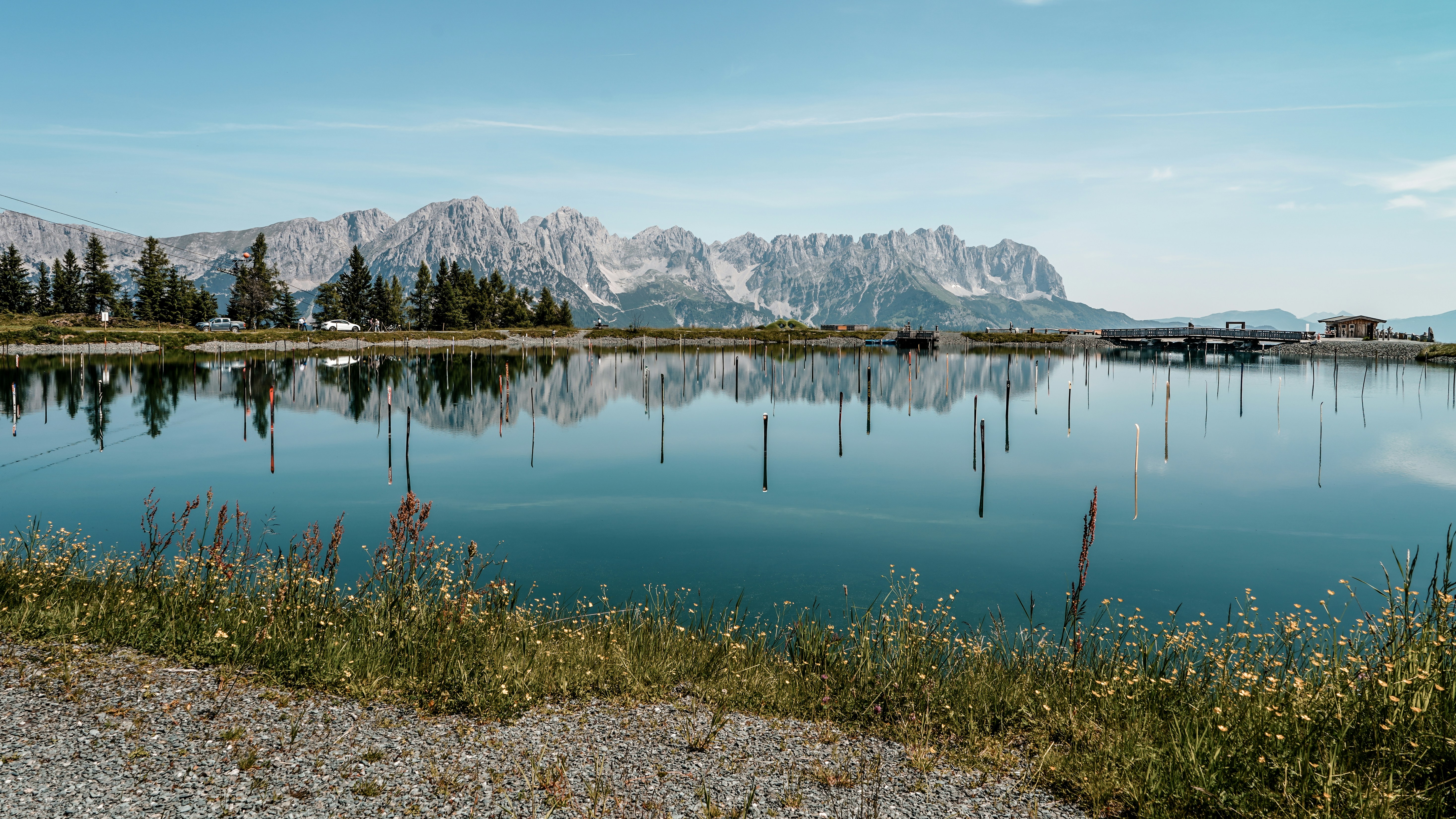 Mountains and their reflection sit in the still water.