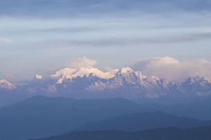 Snow-capped mountains under a beautiful, cloudy sky.