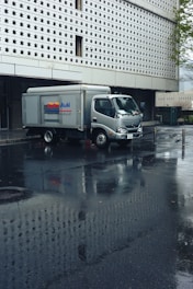 A delivery truck parked in front of a building.
