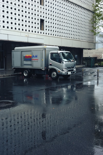 A delivery truck parked in front of a building.