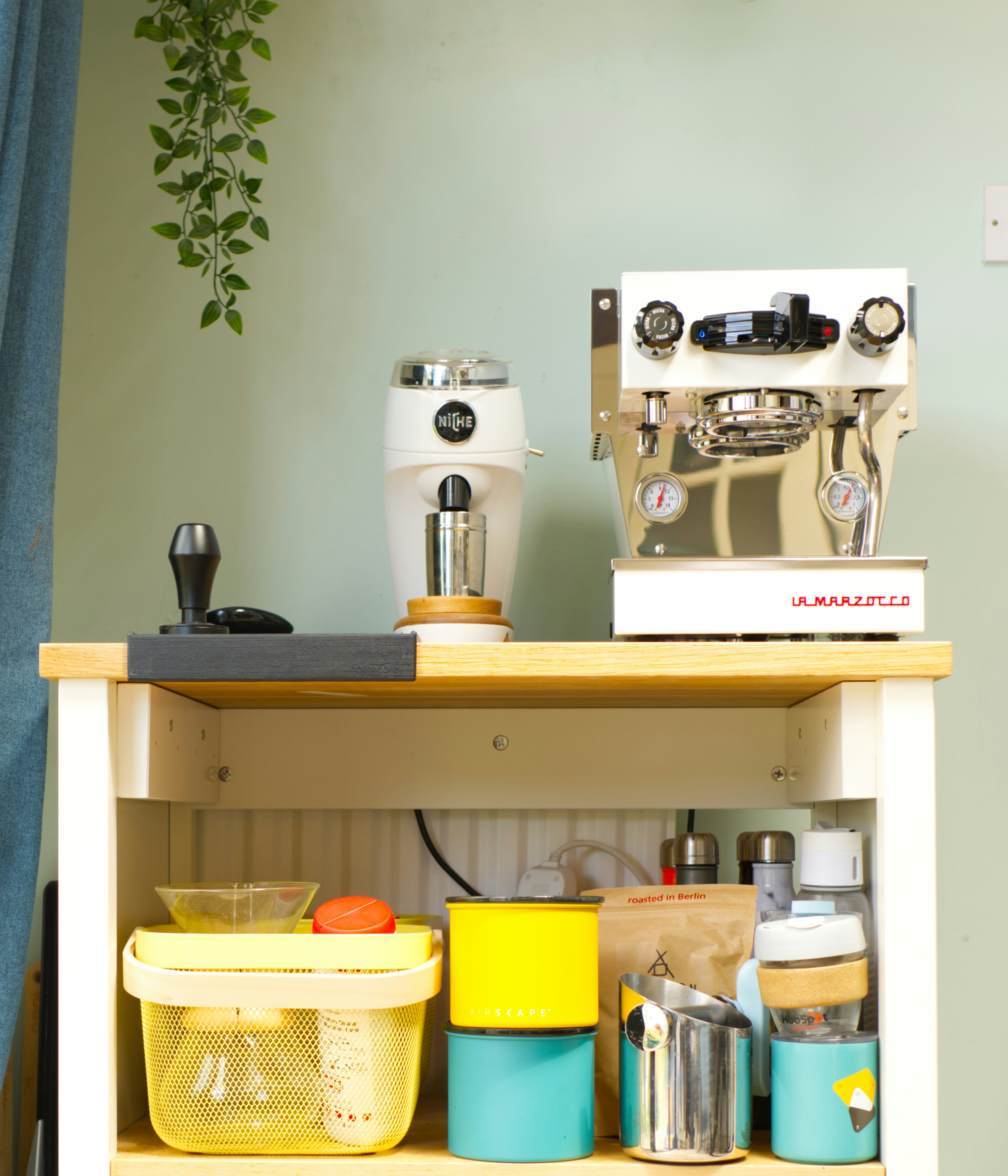 Coffee station with espresso machine and grinder.