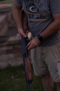 Man loads a shotgun with shells.