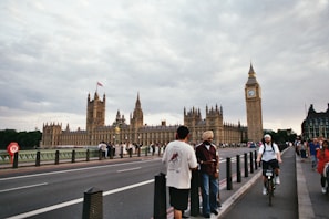 People visit the palace of westminster and big ben.