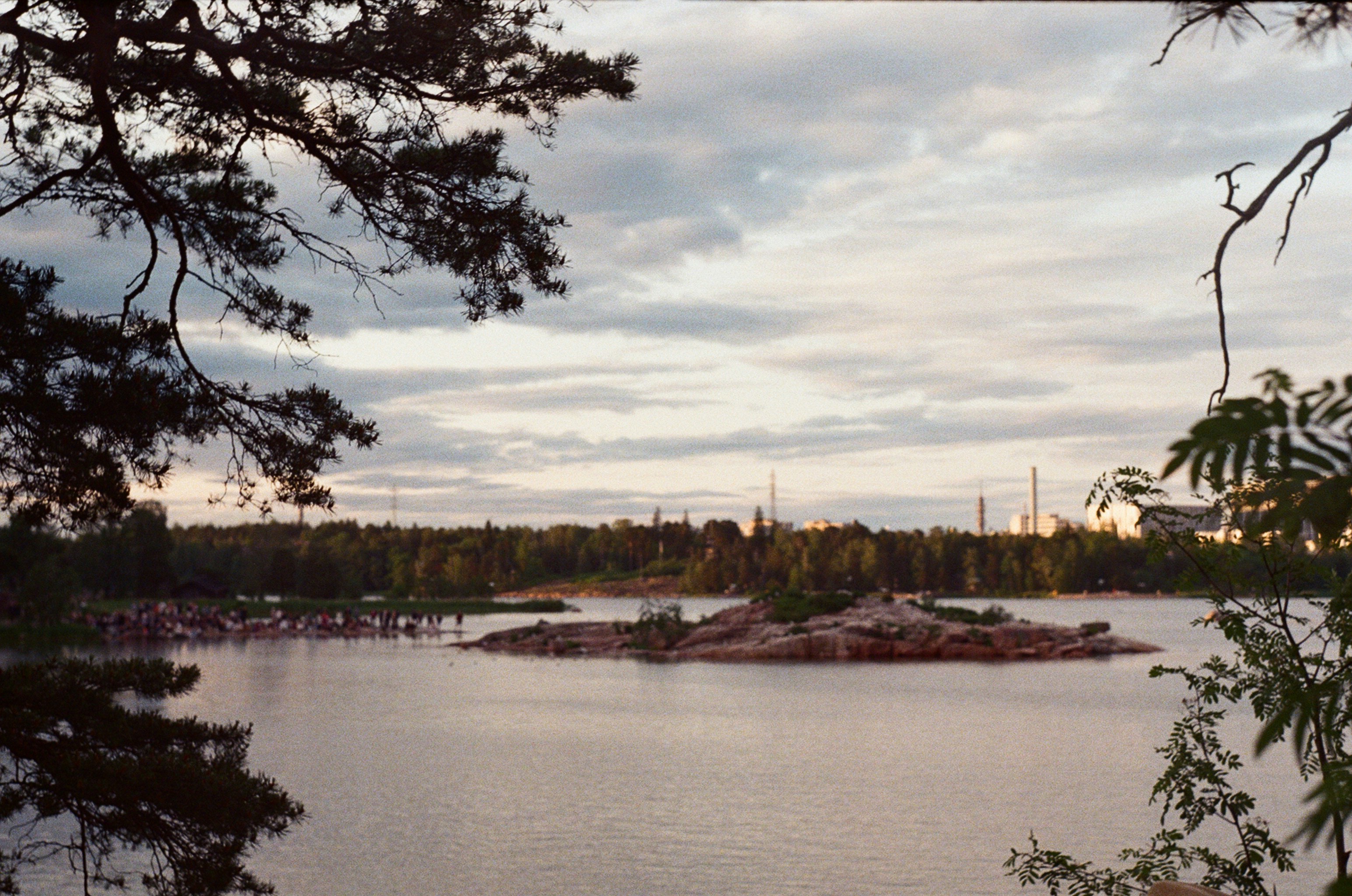 A serene lake scene under a cloudy sky.