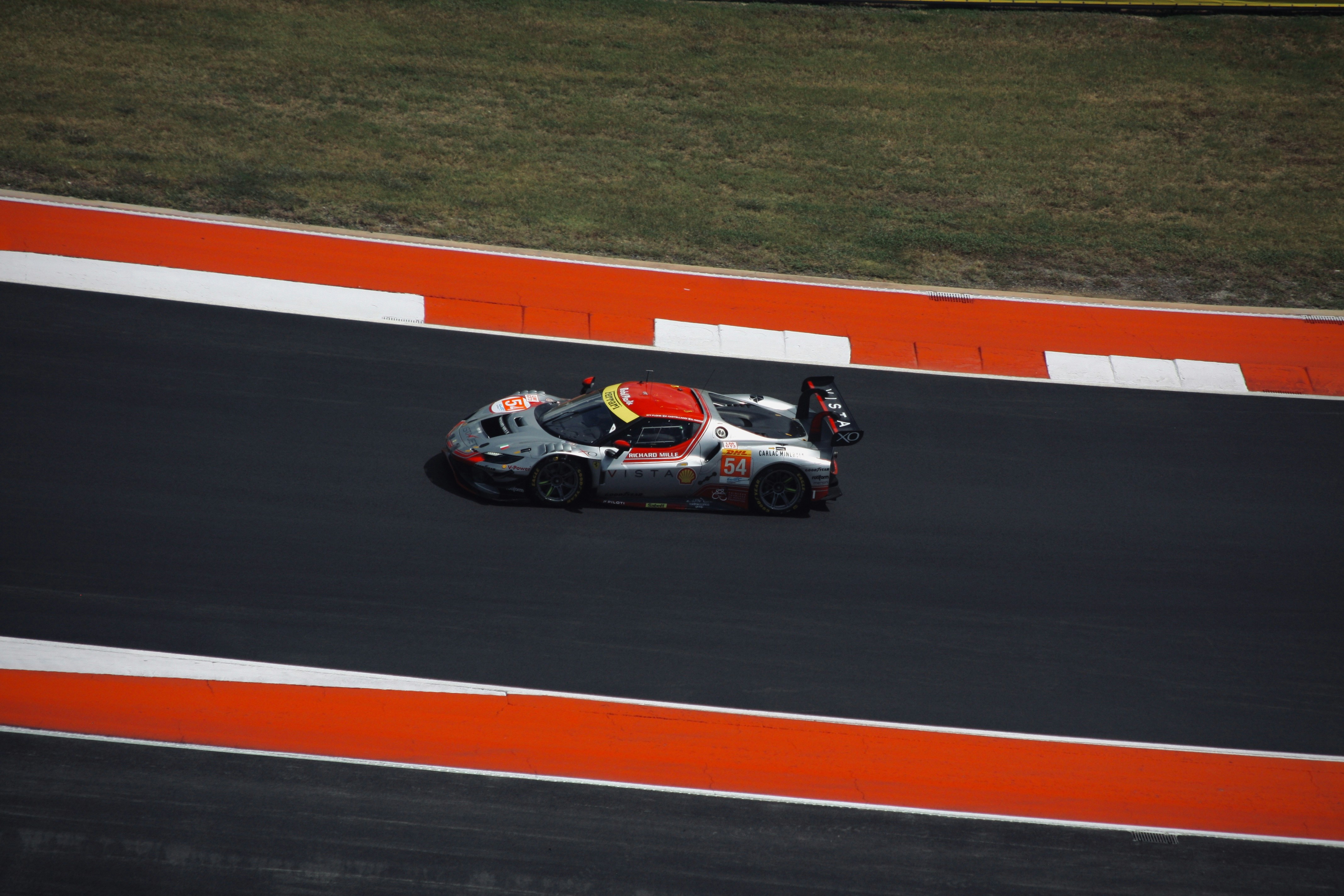 A race car speeds around the track.