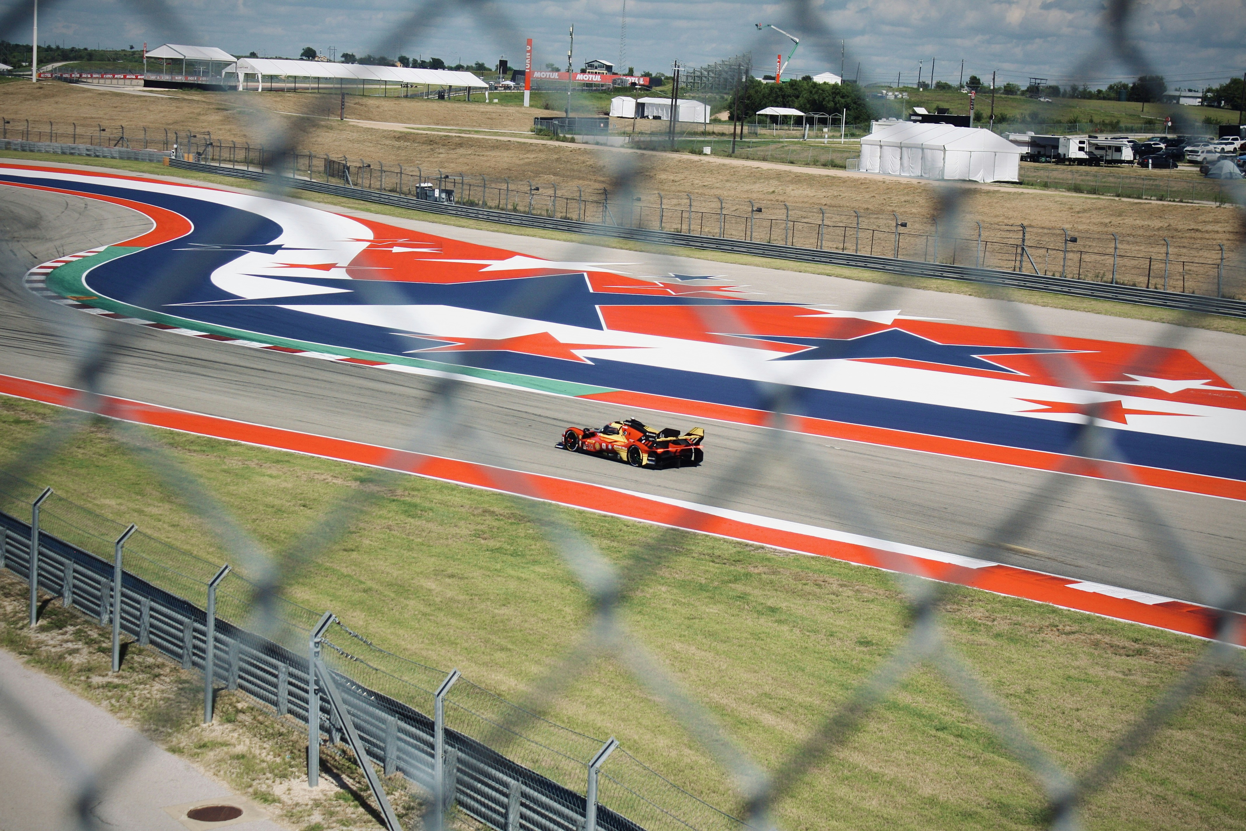 A formula 1 car races on a colorful track.