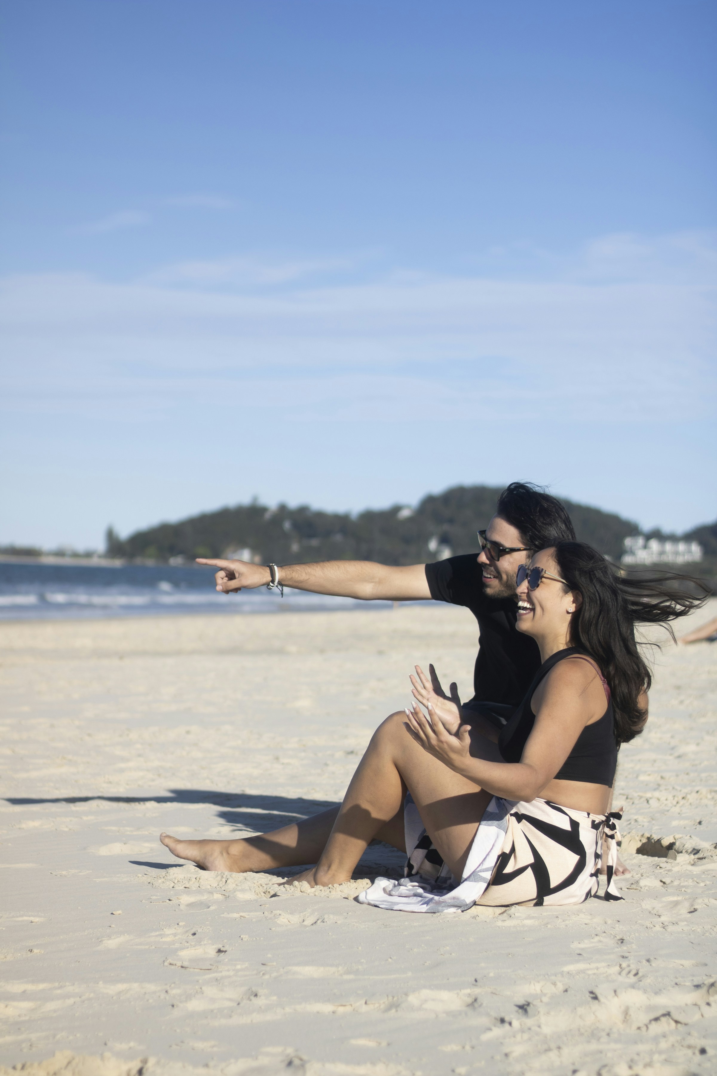 Couple enjoys a sunny day at the beach.