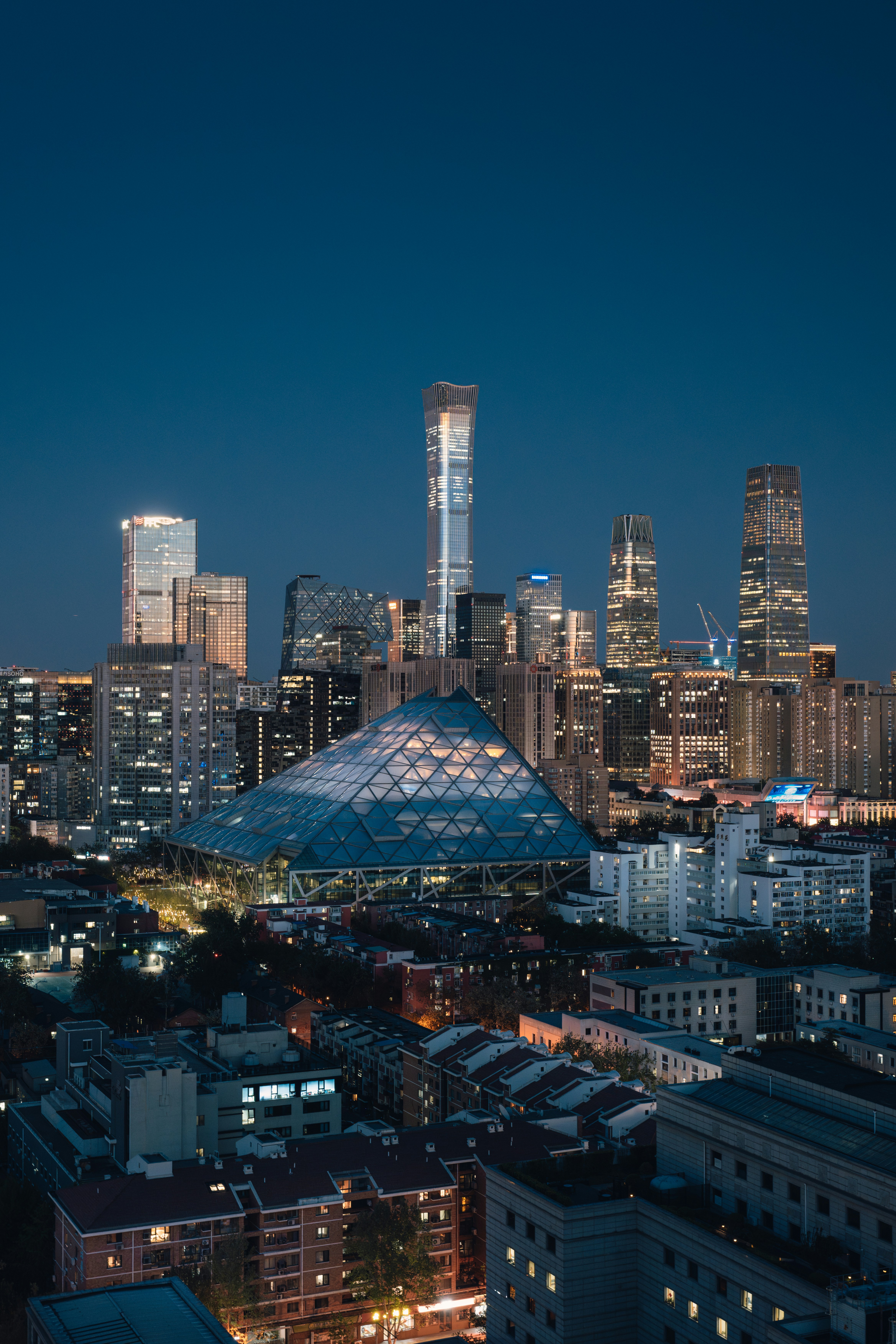 City skyline illuminated at dusk.