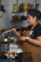 A chef cooks food in a busy kitchen.