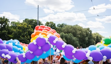 A pride parade arch made of colorful balloons.