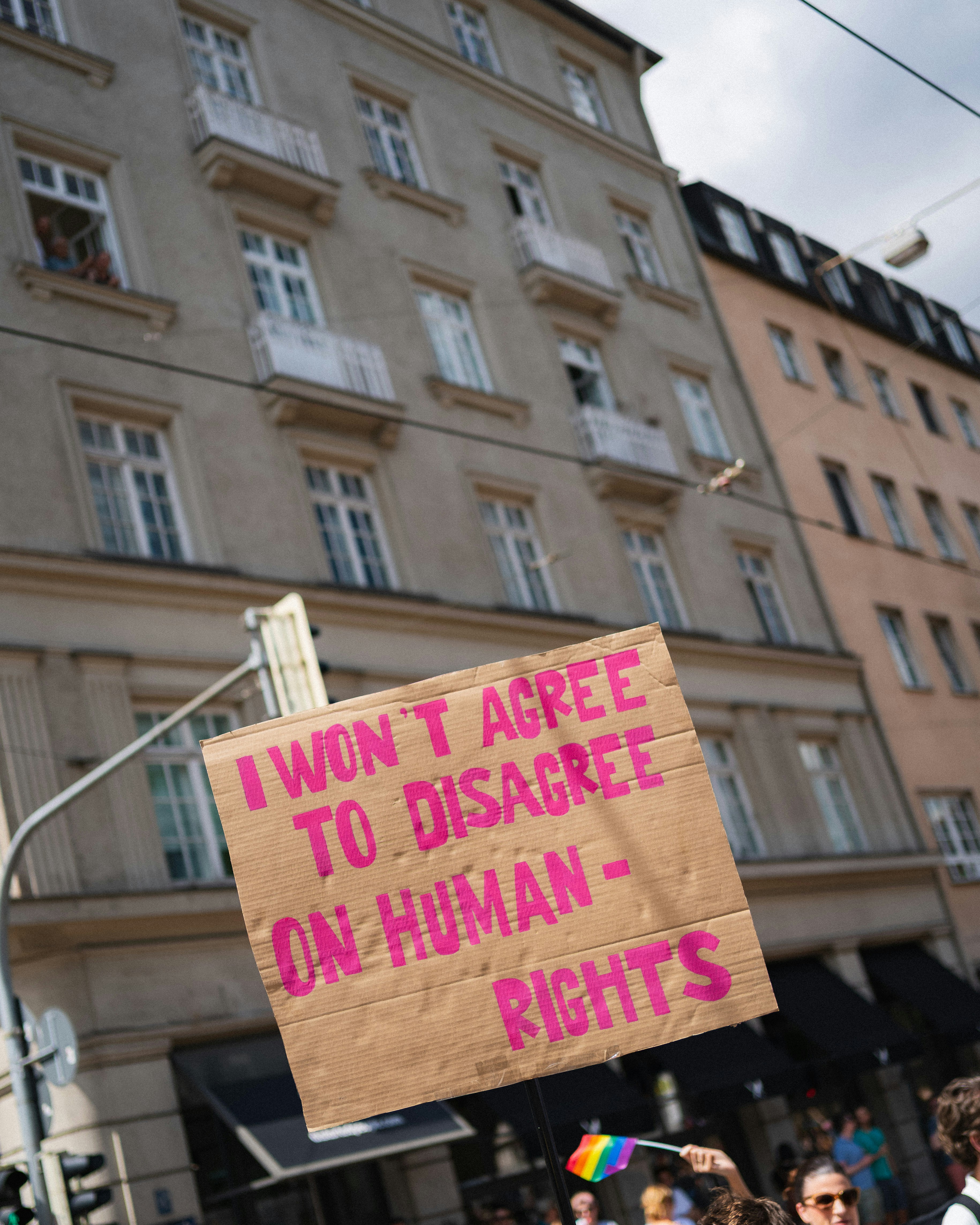 A protestor holds a sign about human rights.
