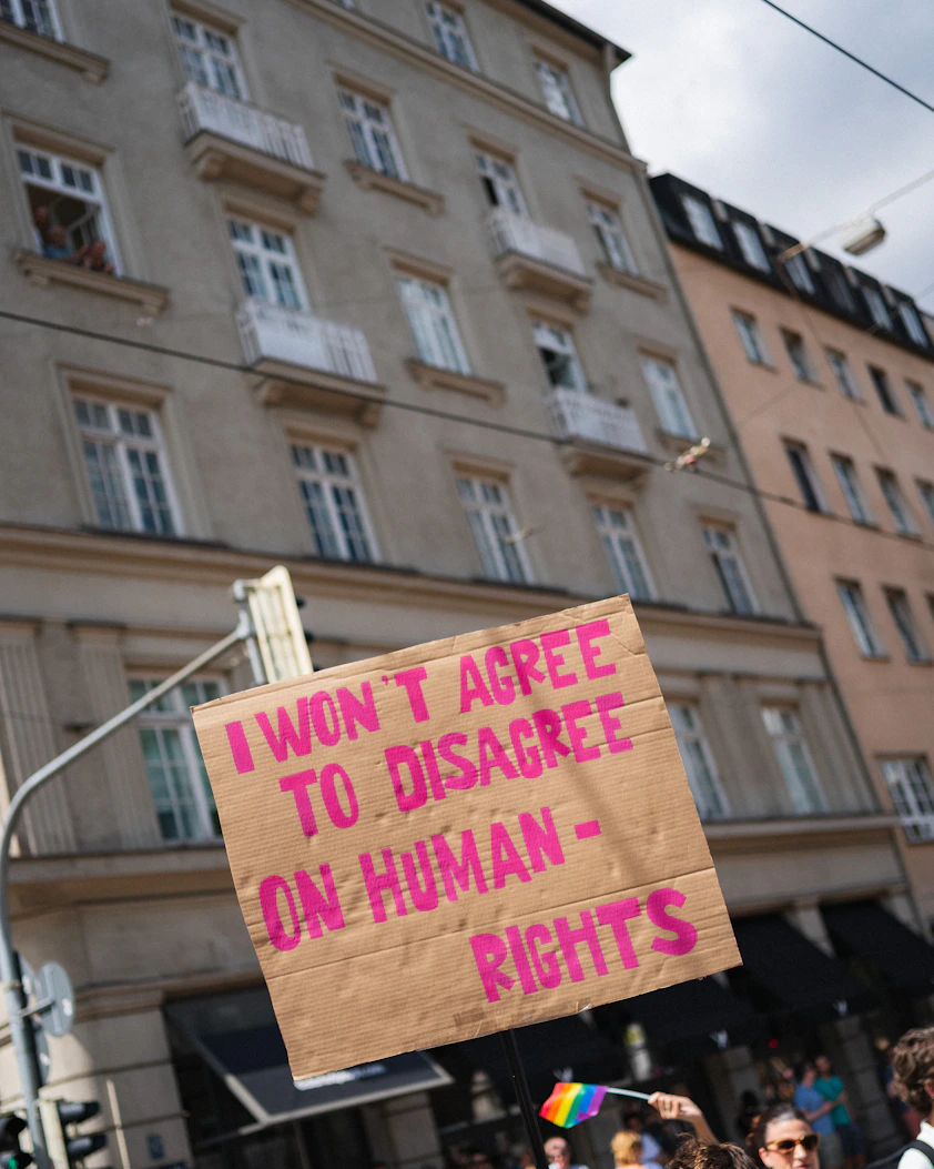 A protestor holds a sign about human rights.