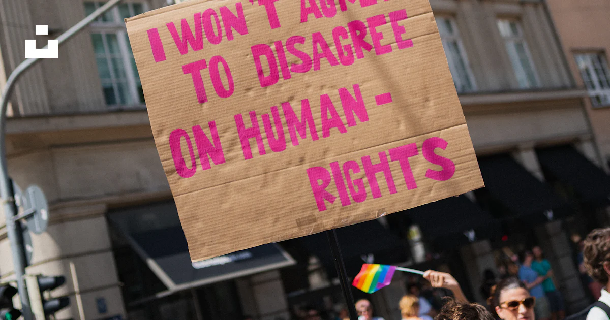 Pro Human Rights Signs A protestor holds a sign about human rights. photo – Free Munich Image ...