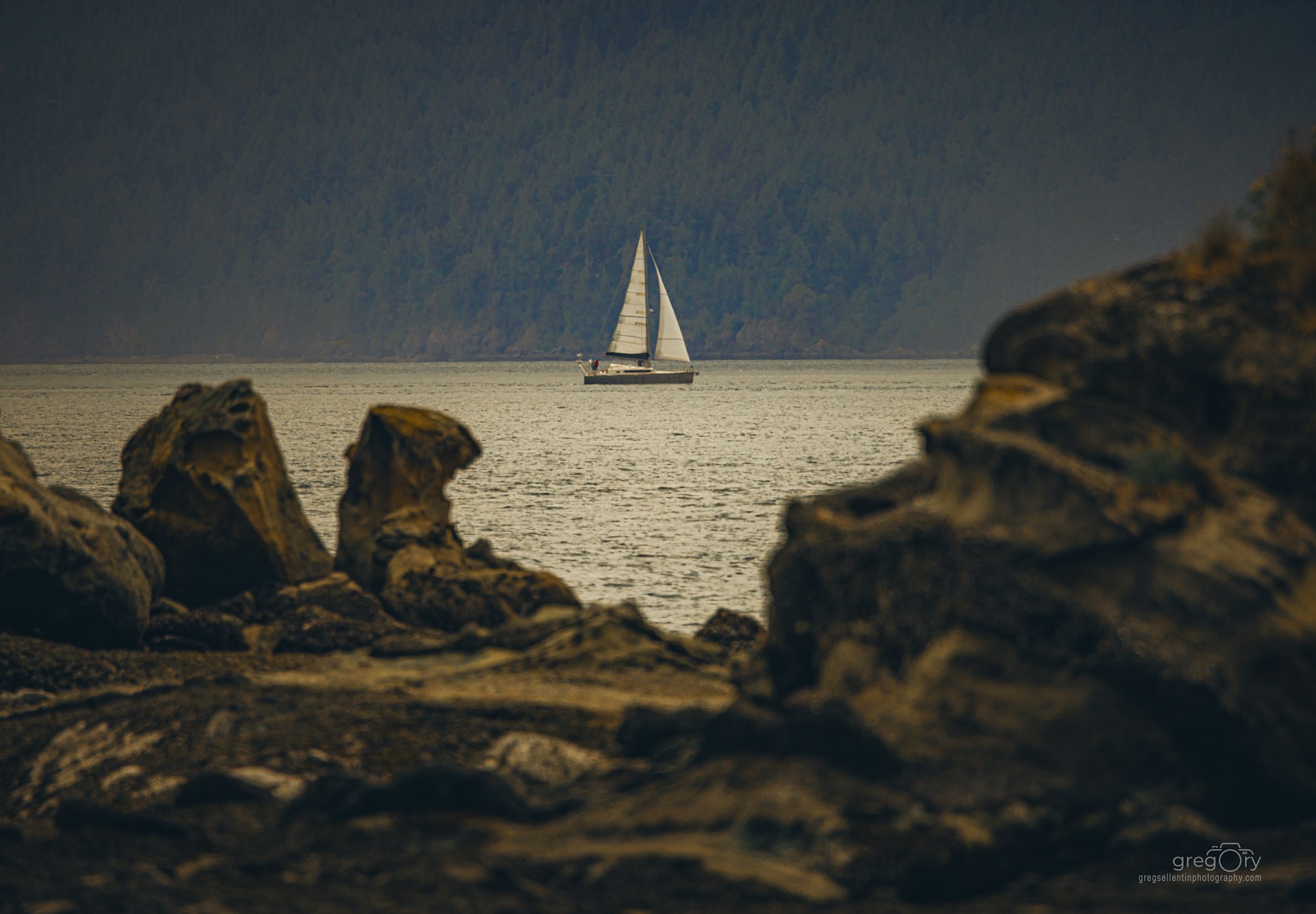 A sailboat sails across the water.