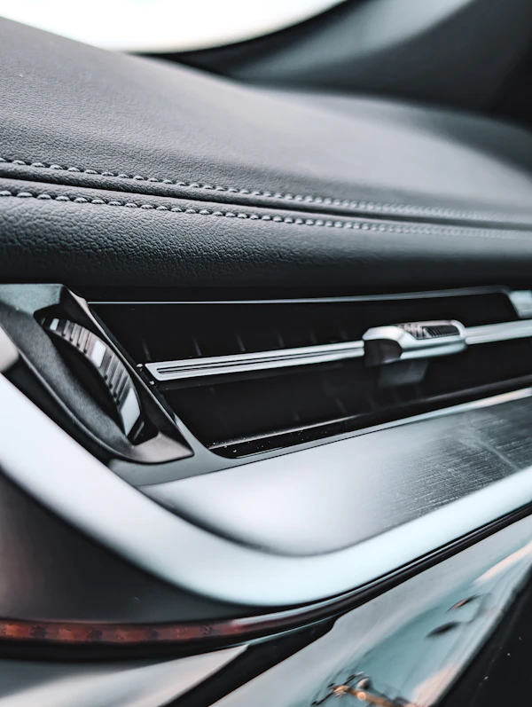 Close-up of a car dashboard air conditioning vent