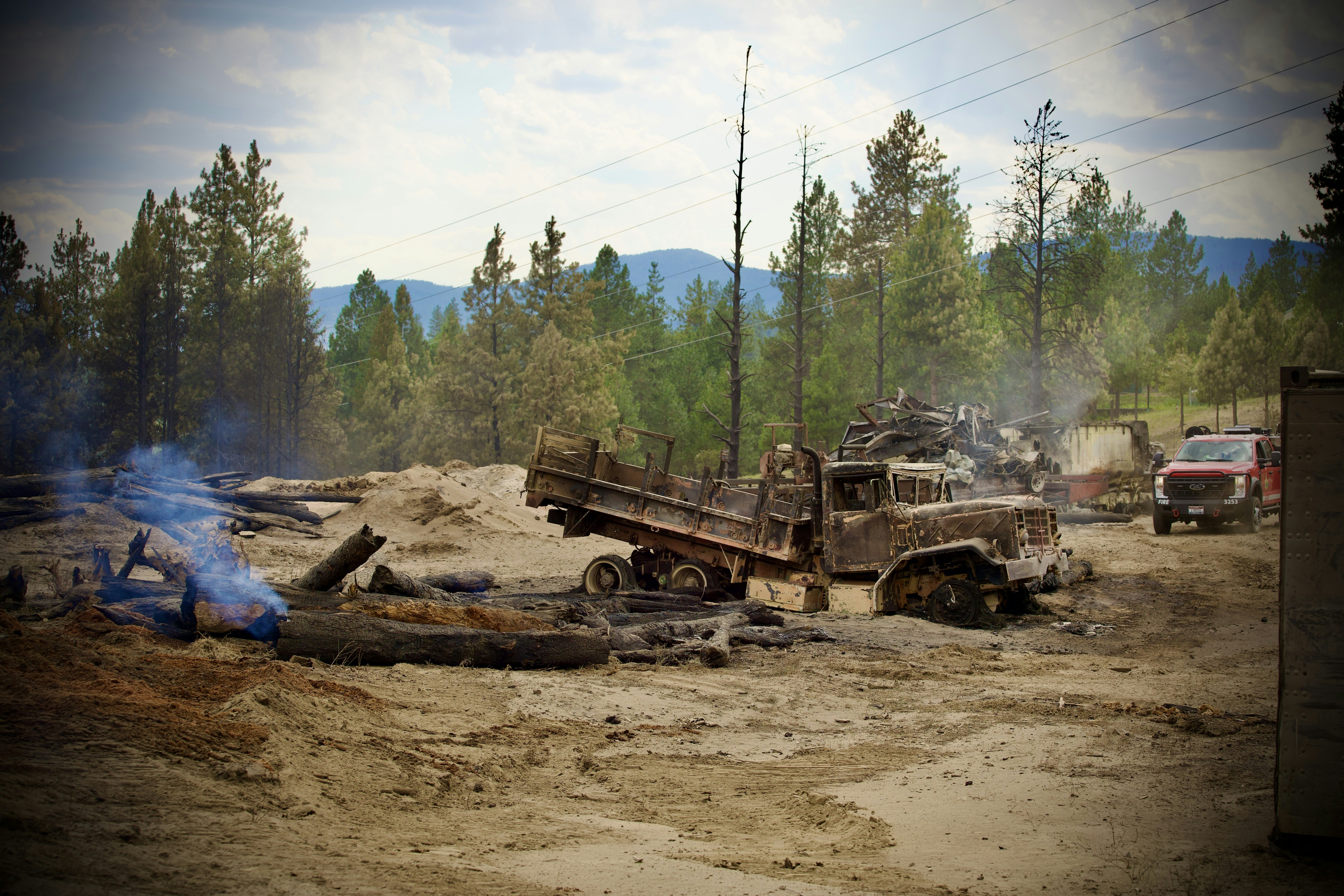 An old truck is near the burnt area.