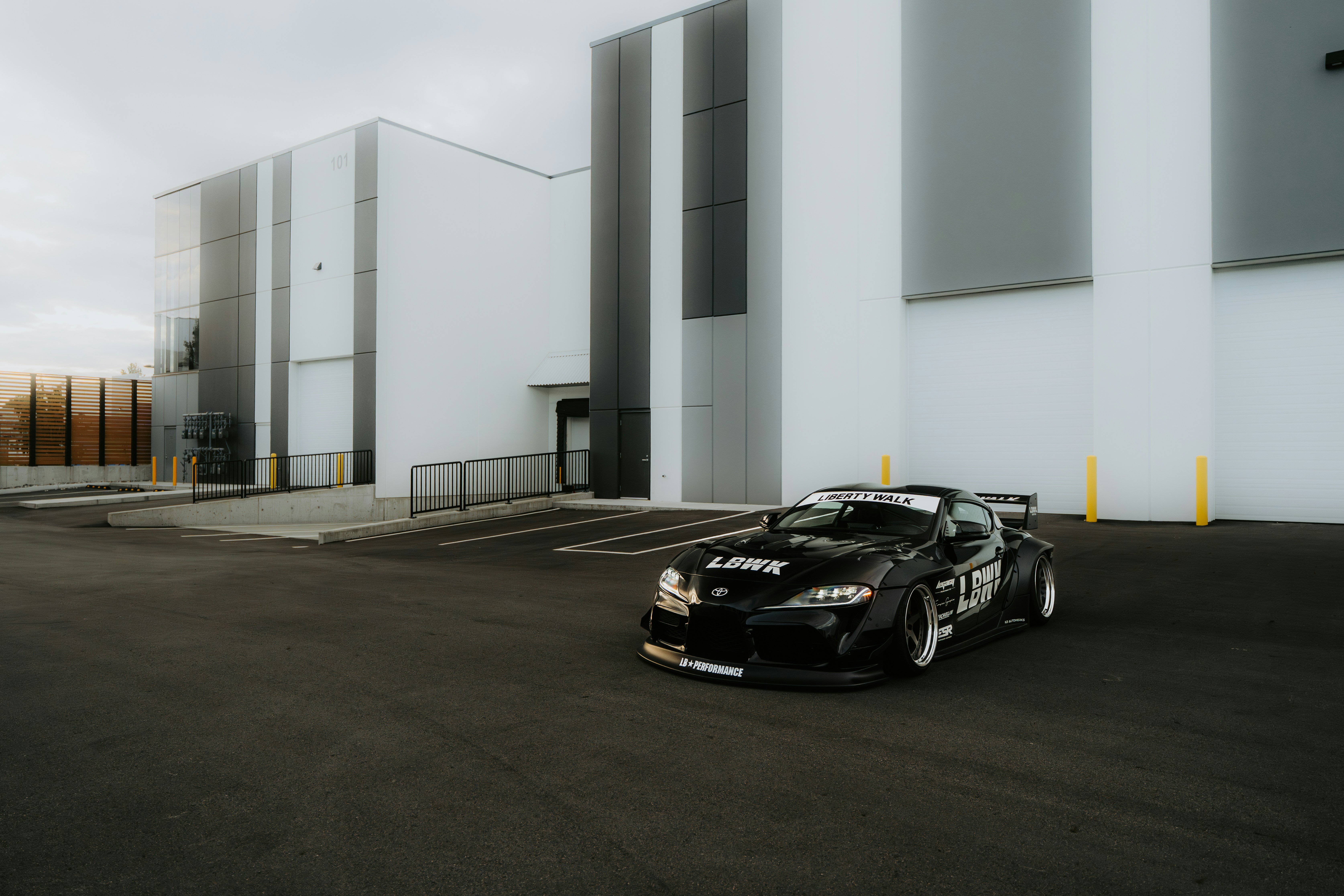 A black sports car parked near a building.