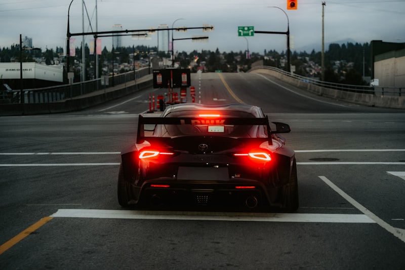 A sporty car is stopped at a traffic light.