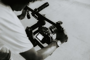 A person is holding a camera on a rig.