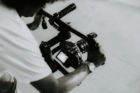 A person is holding a camera on a rig.