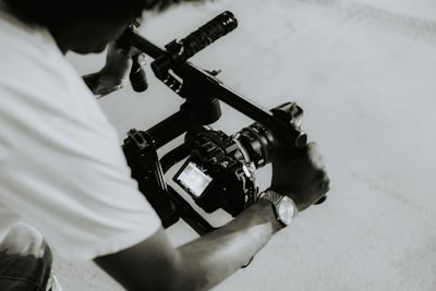 A person is holding a camera on a rig.