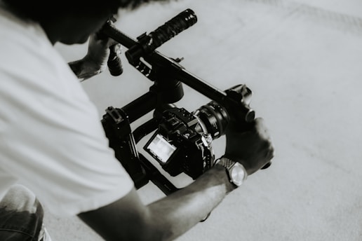 A person is holding a camera on a rig.