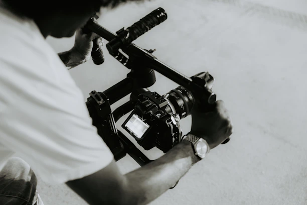 A person is holding a camera on a rig.