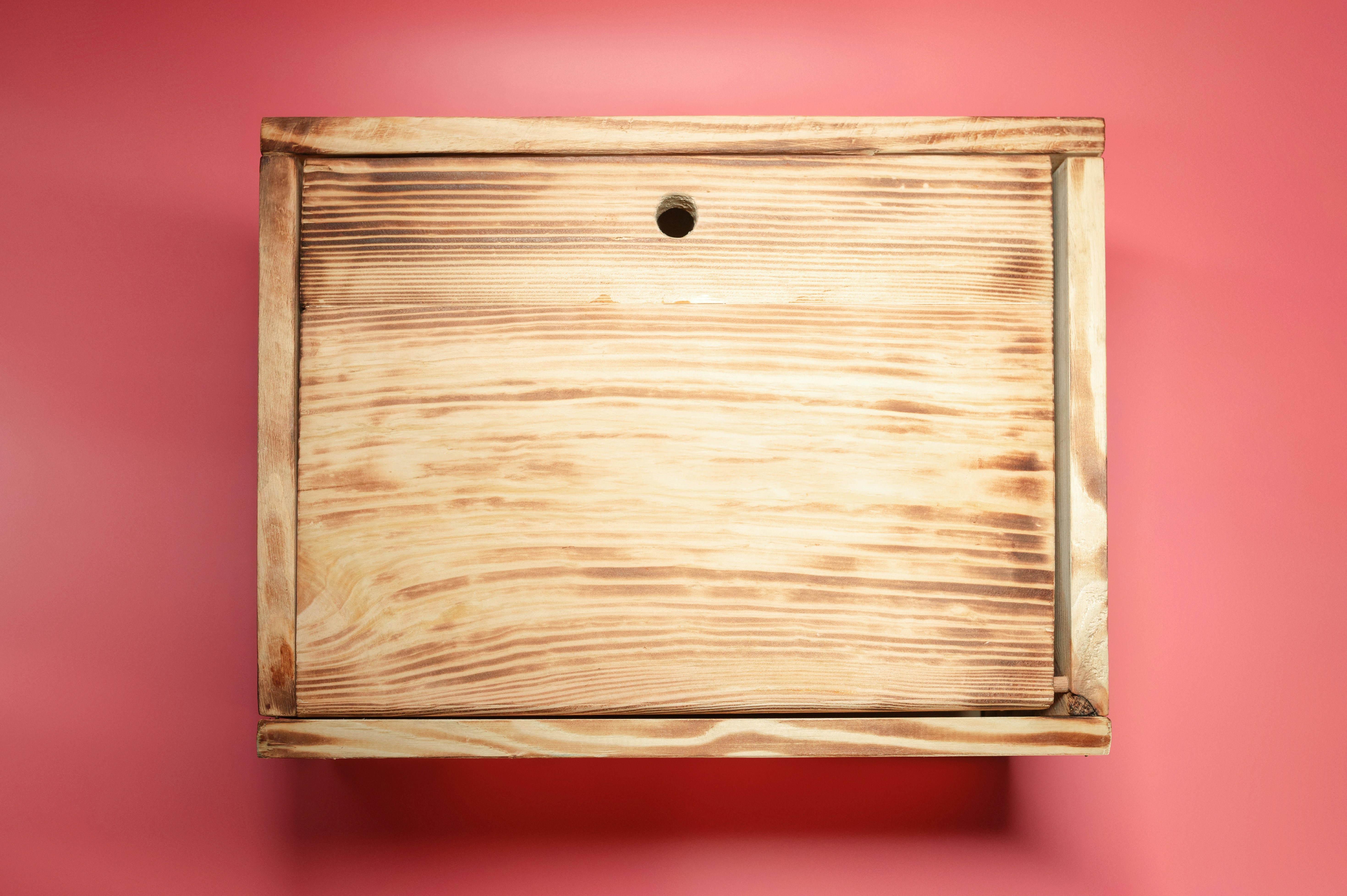 Wooden box with a circular hole