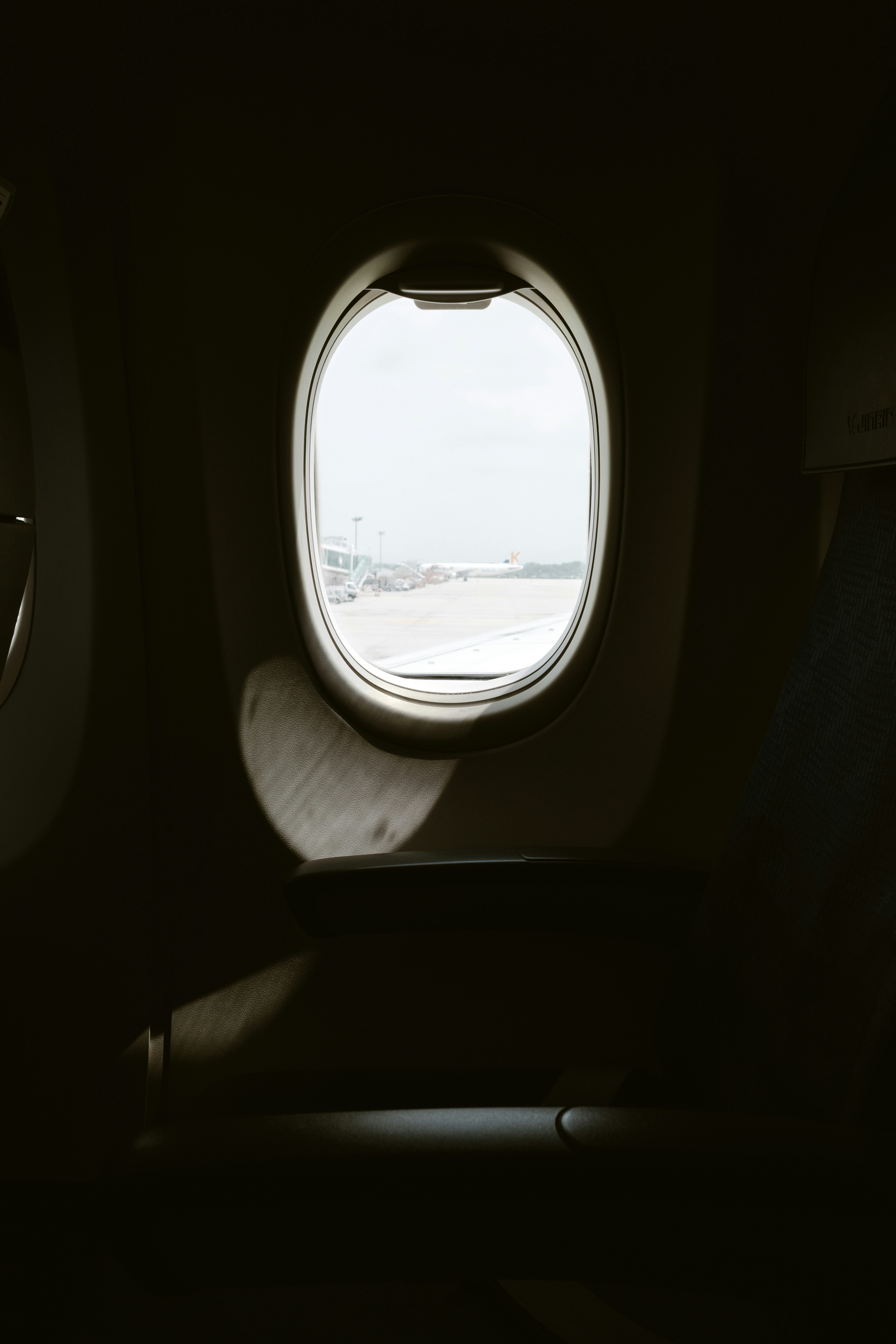 Airplane window view with the outside sunlight.