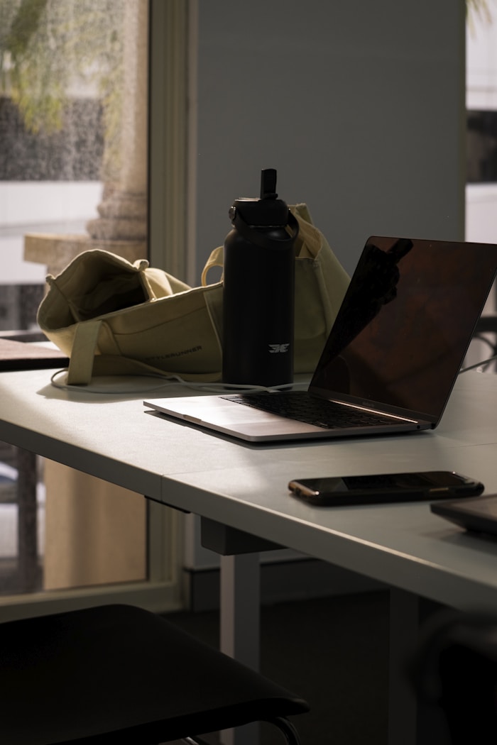 Laptop and water bottle on a study table