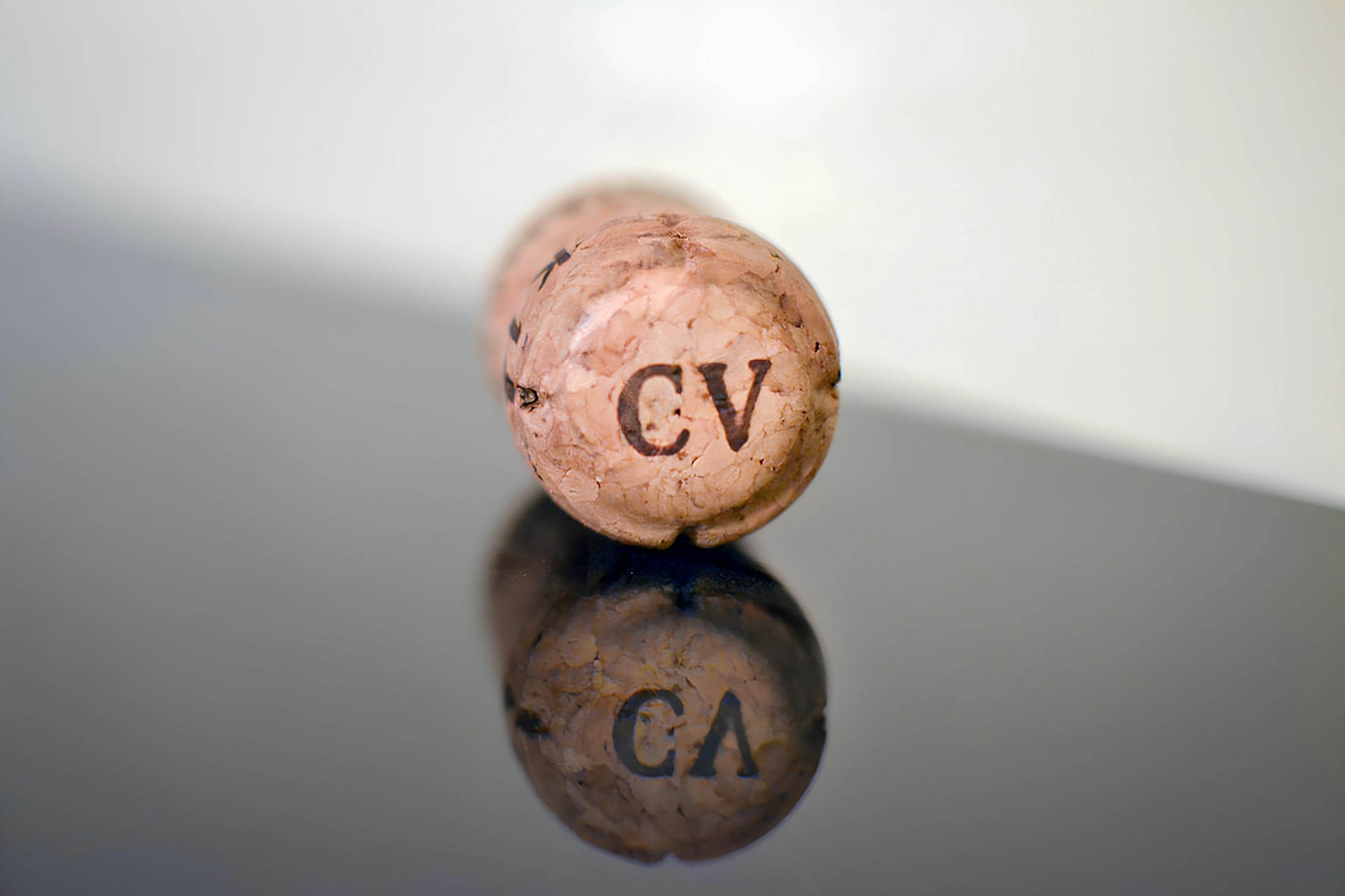 A cork with the letters "cv" reflects.