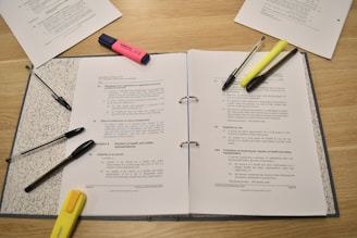Papers, pens, and highlighters are laid out for studying.