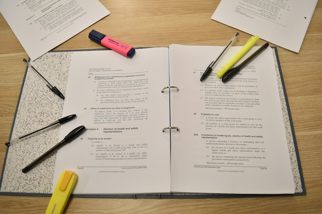 Printed document with pens and highlighters ready for review