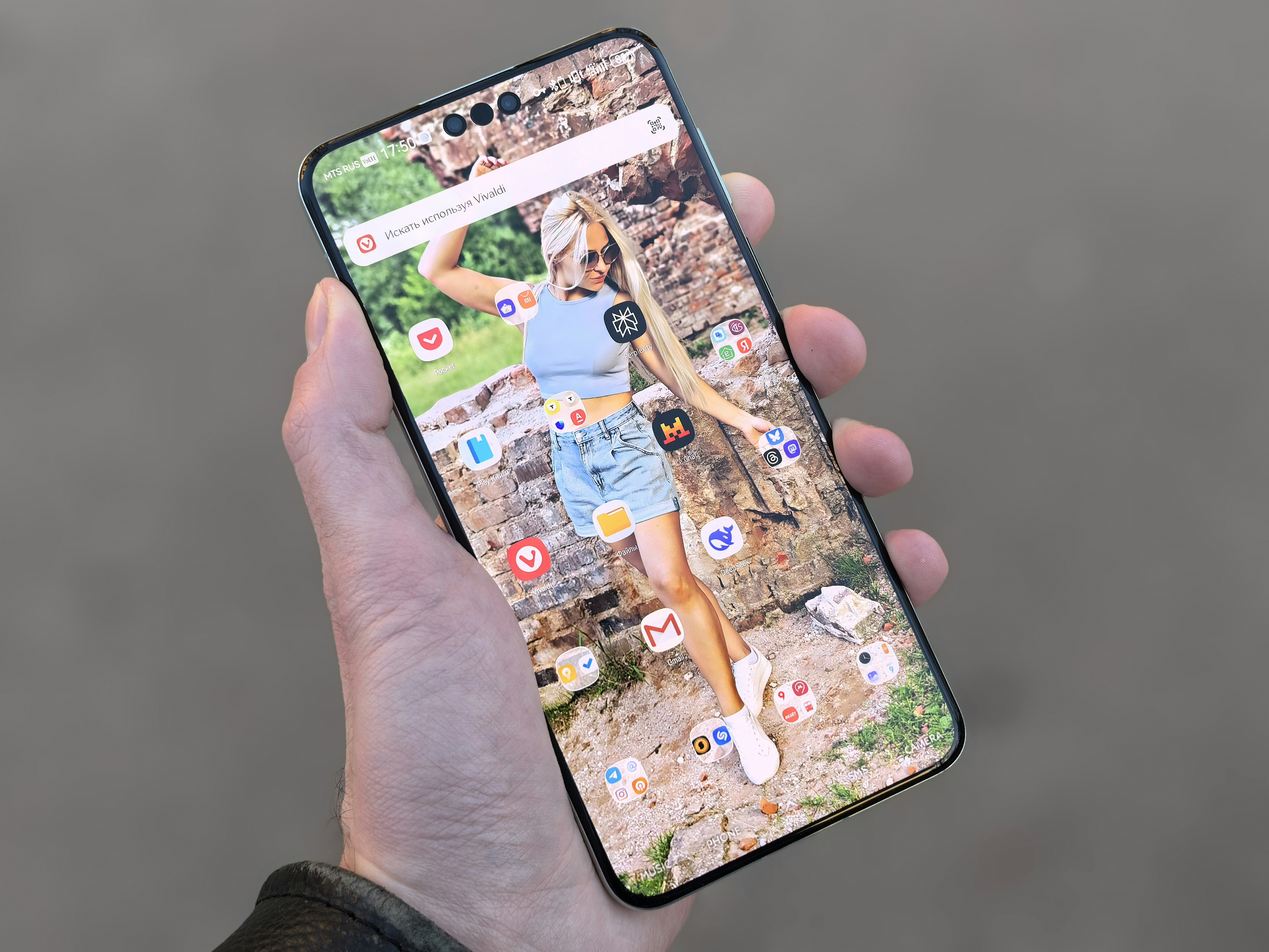 A smartphone shows a photo of a woman