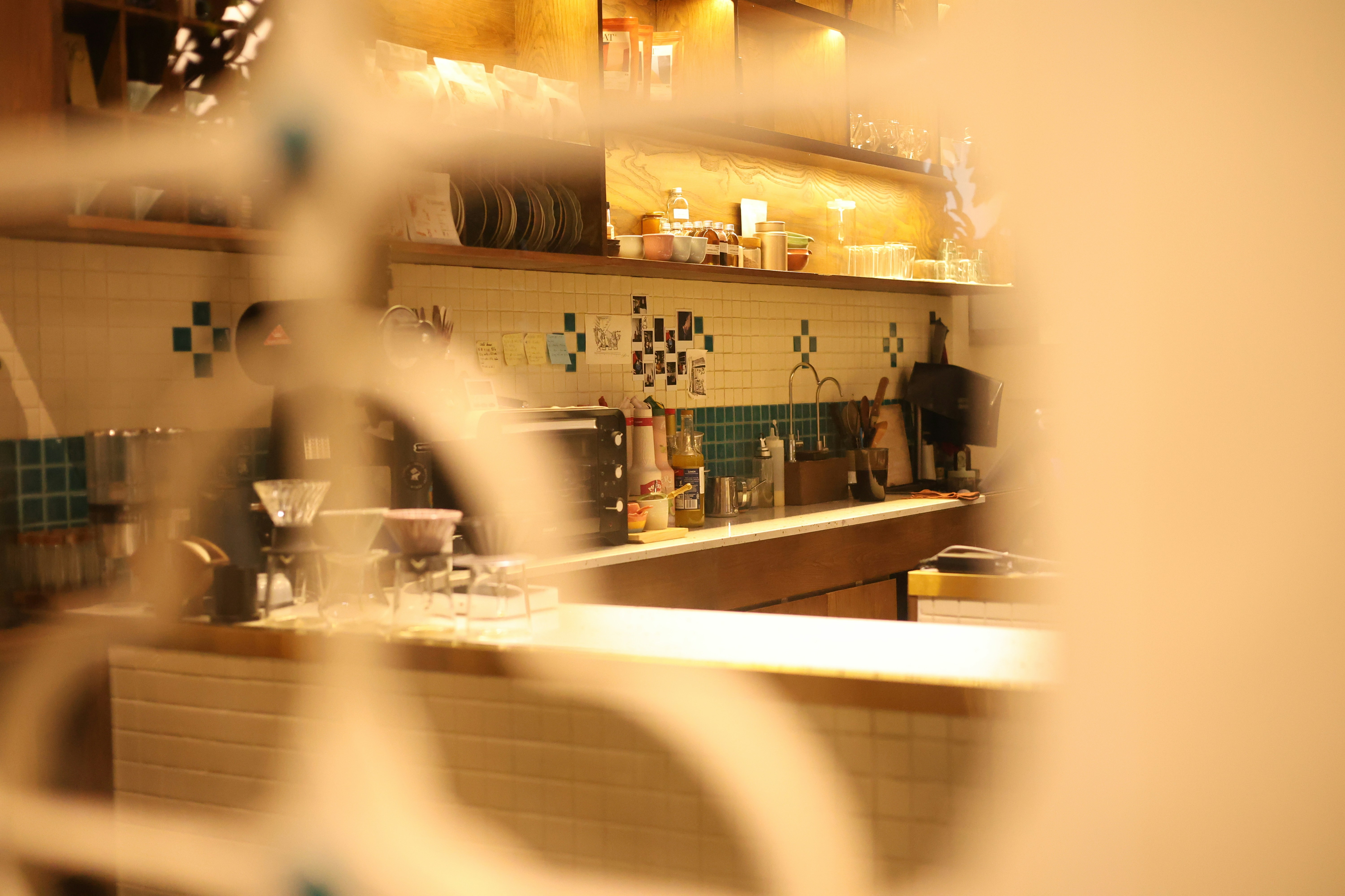 A café counter is viewed through a white design.