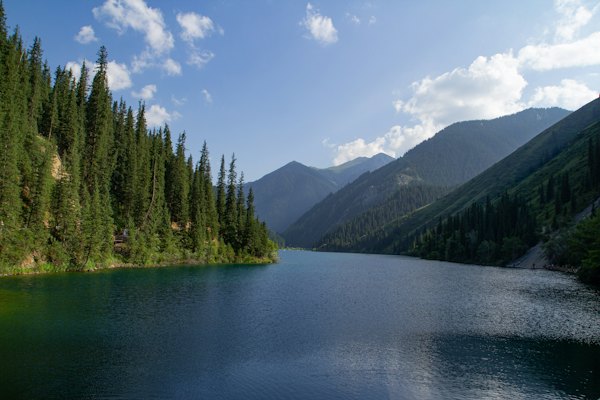A scenic lake is surrounded by mountains and trees — Kolsay Lakes, Kazakhstan