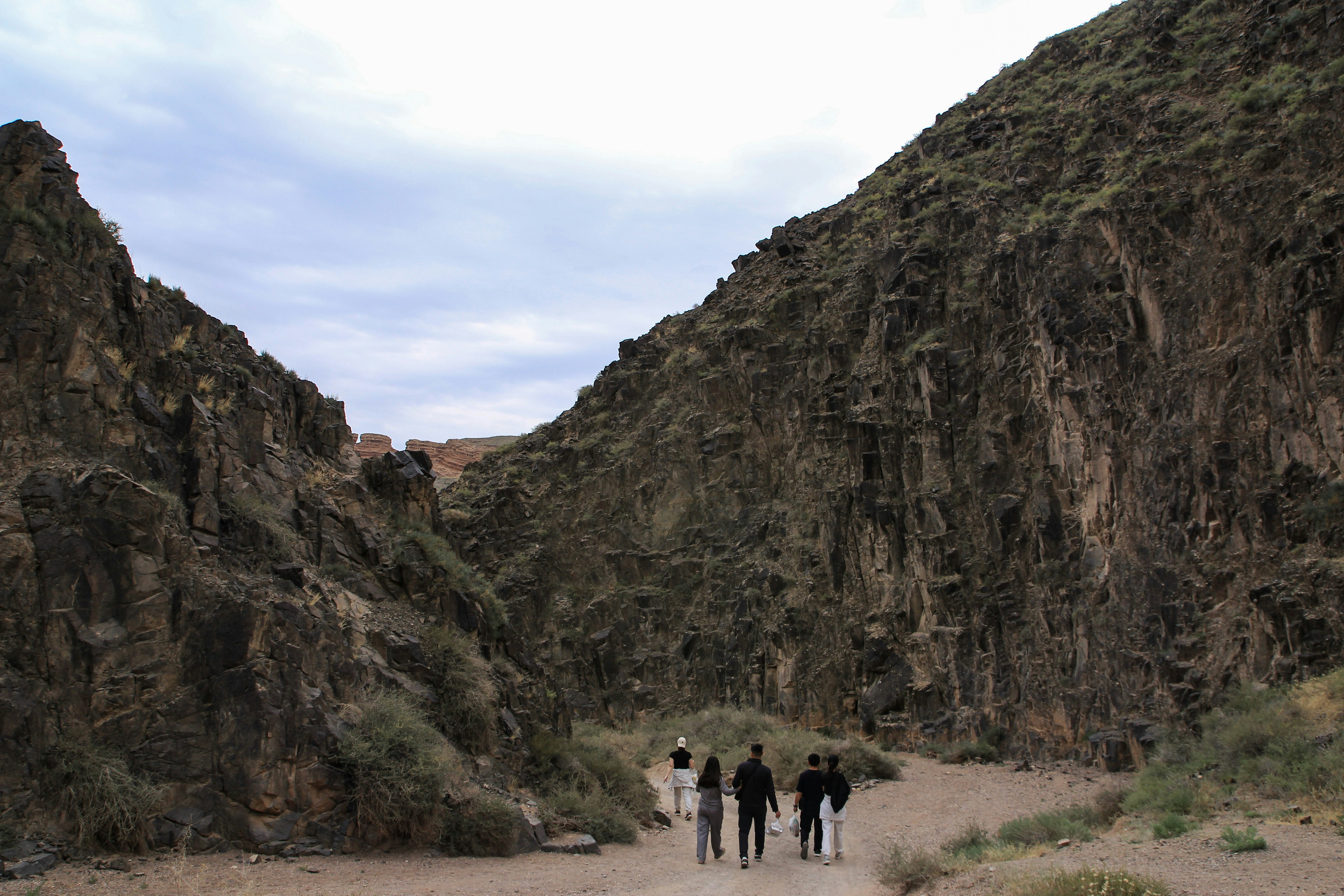 People hike through a canyon.