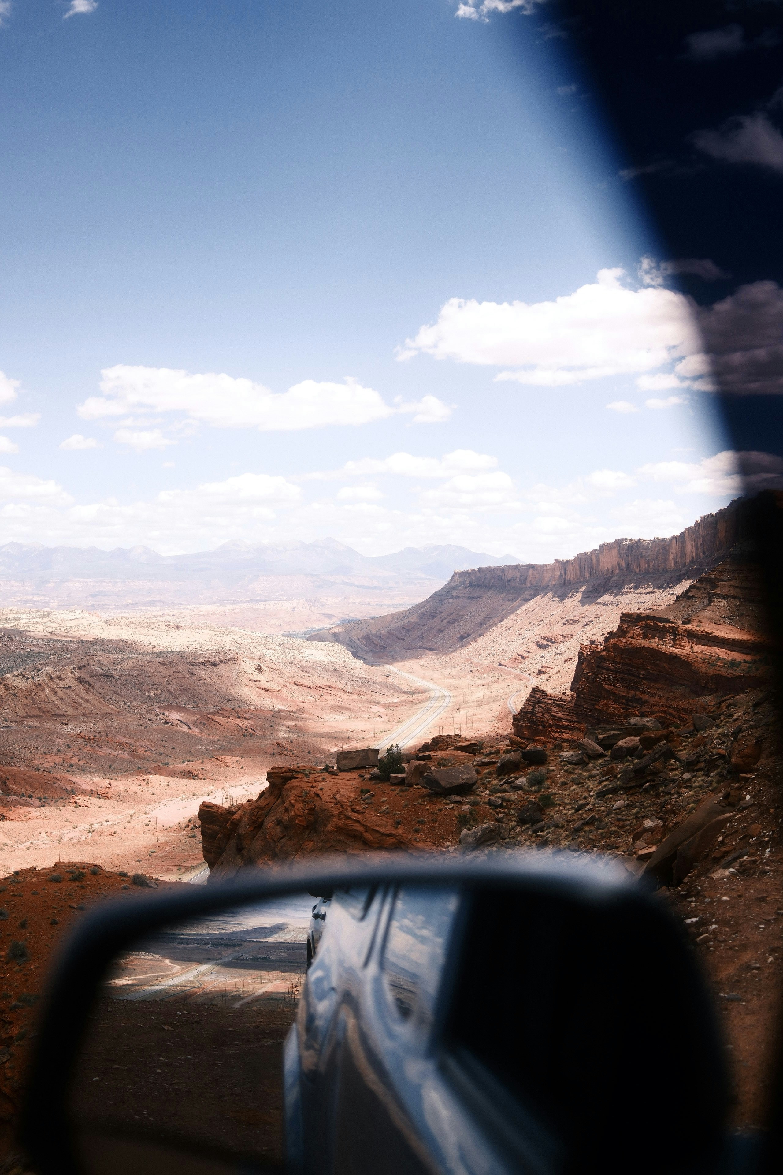 Driving through a desert landscape with a sunny sky.