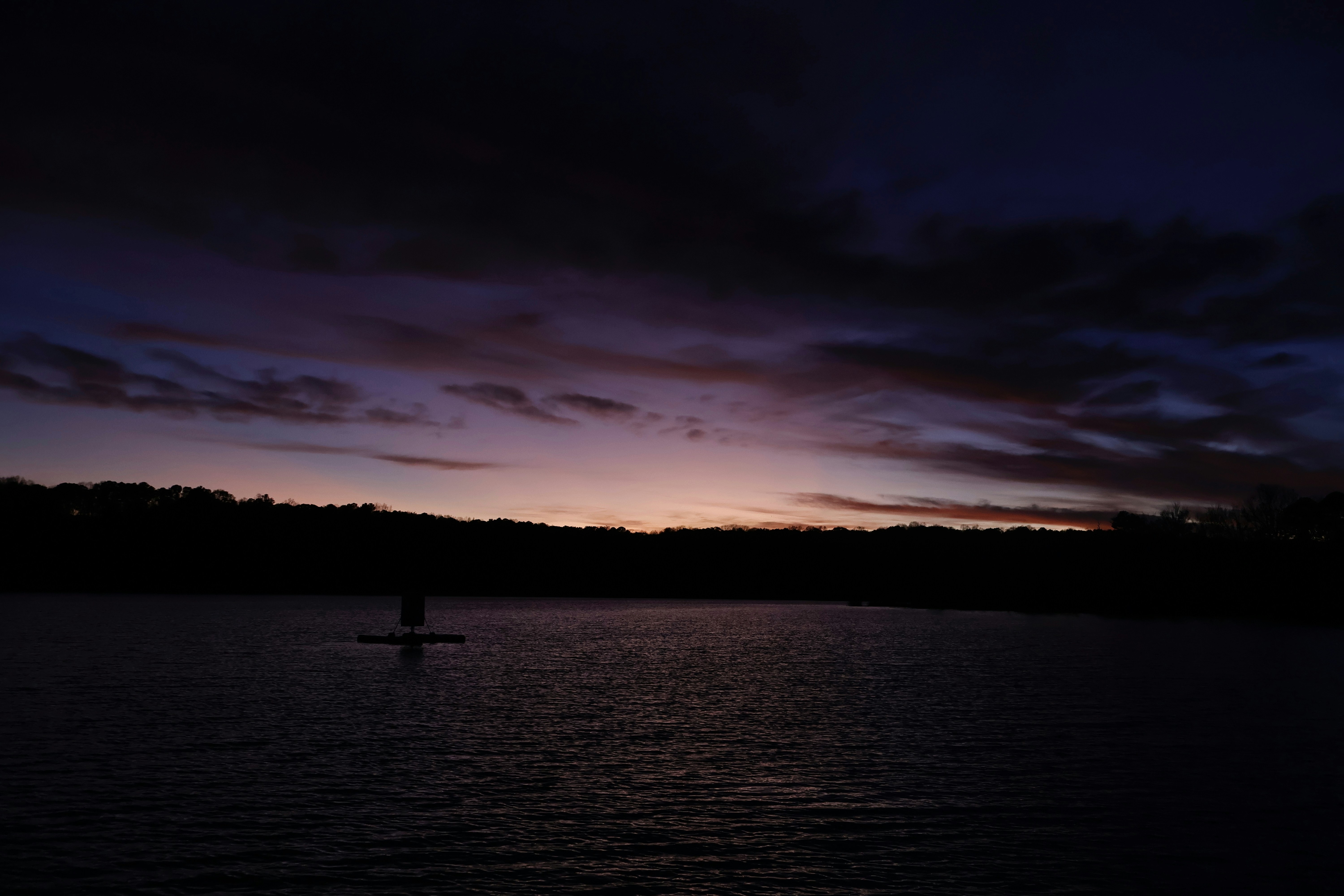 Sunset over a calm lake at twilight.